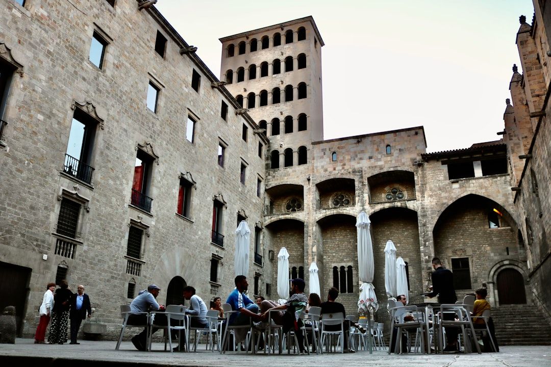 Outdoor dining in Barcelona's Gothic Quarter with historic architecture