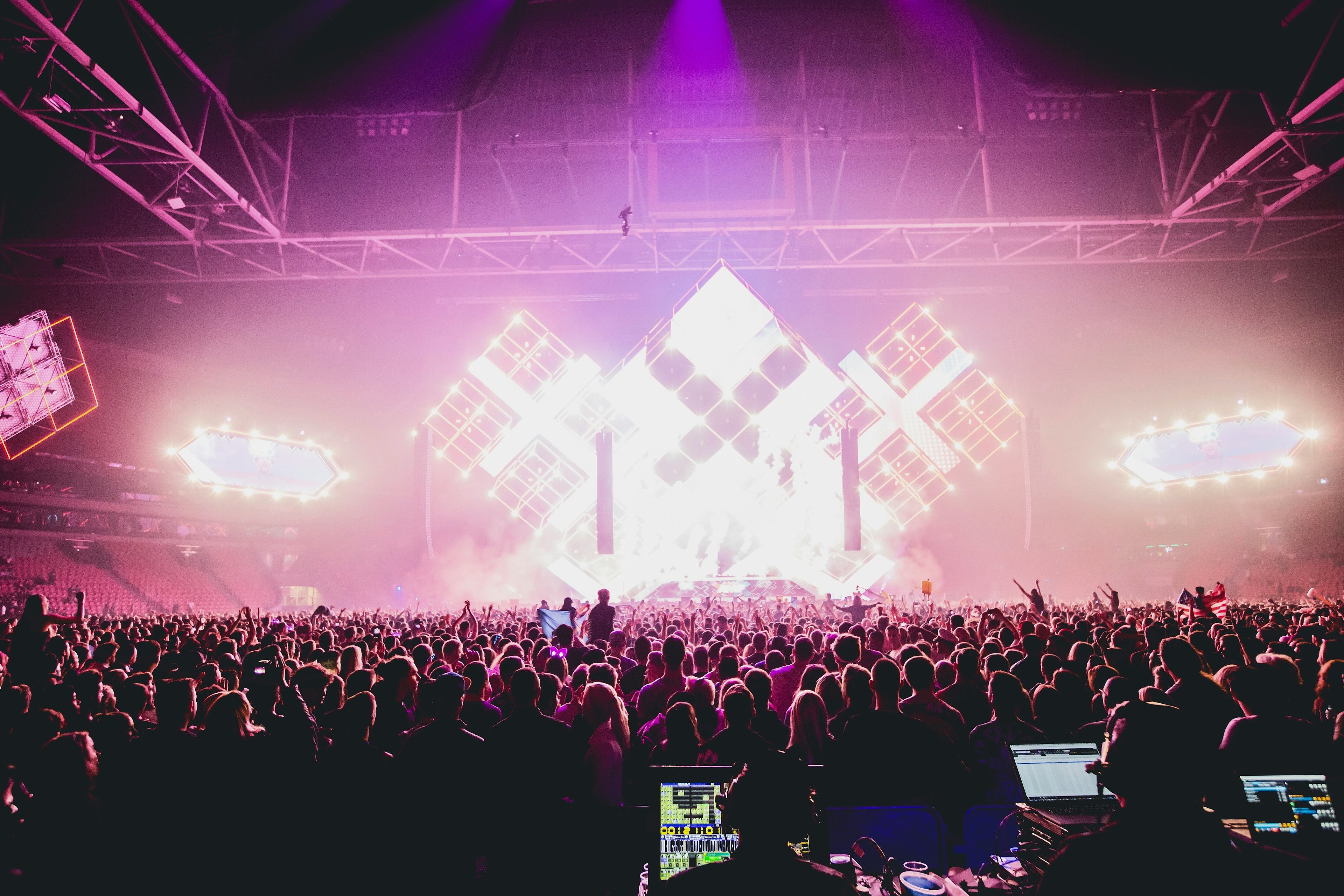 Crowded musical event illuminated by stage lights