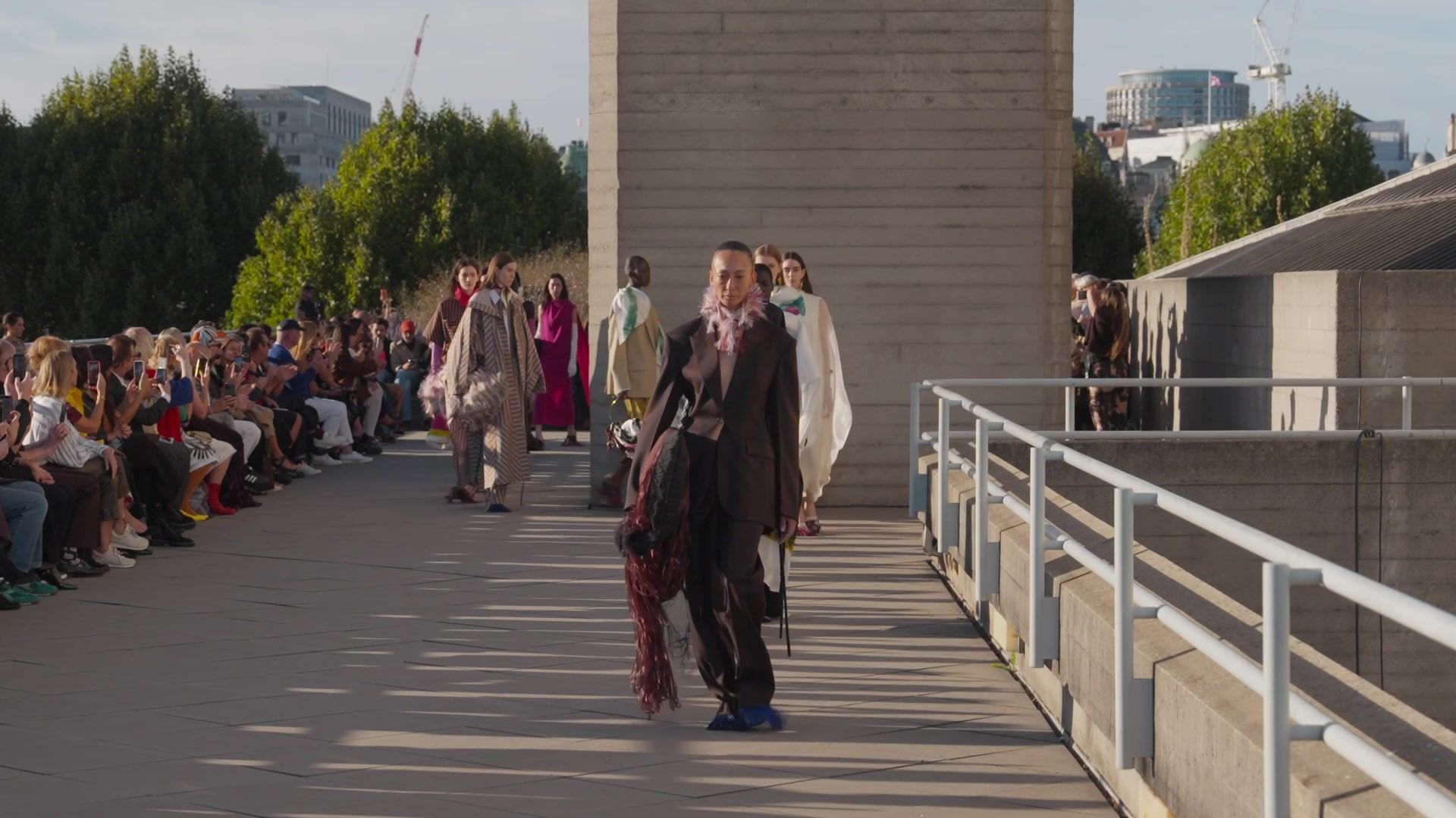 Models walk the finale past guests seated along the runway at Roksanda's September 2026 show