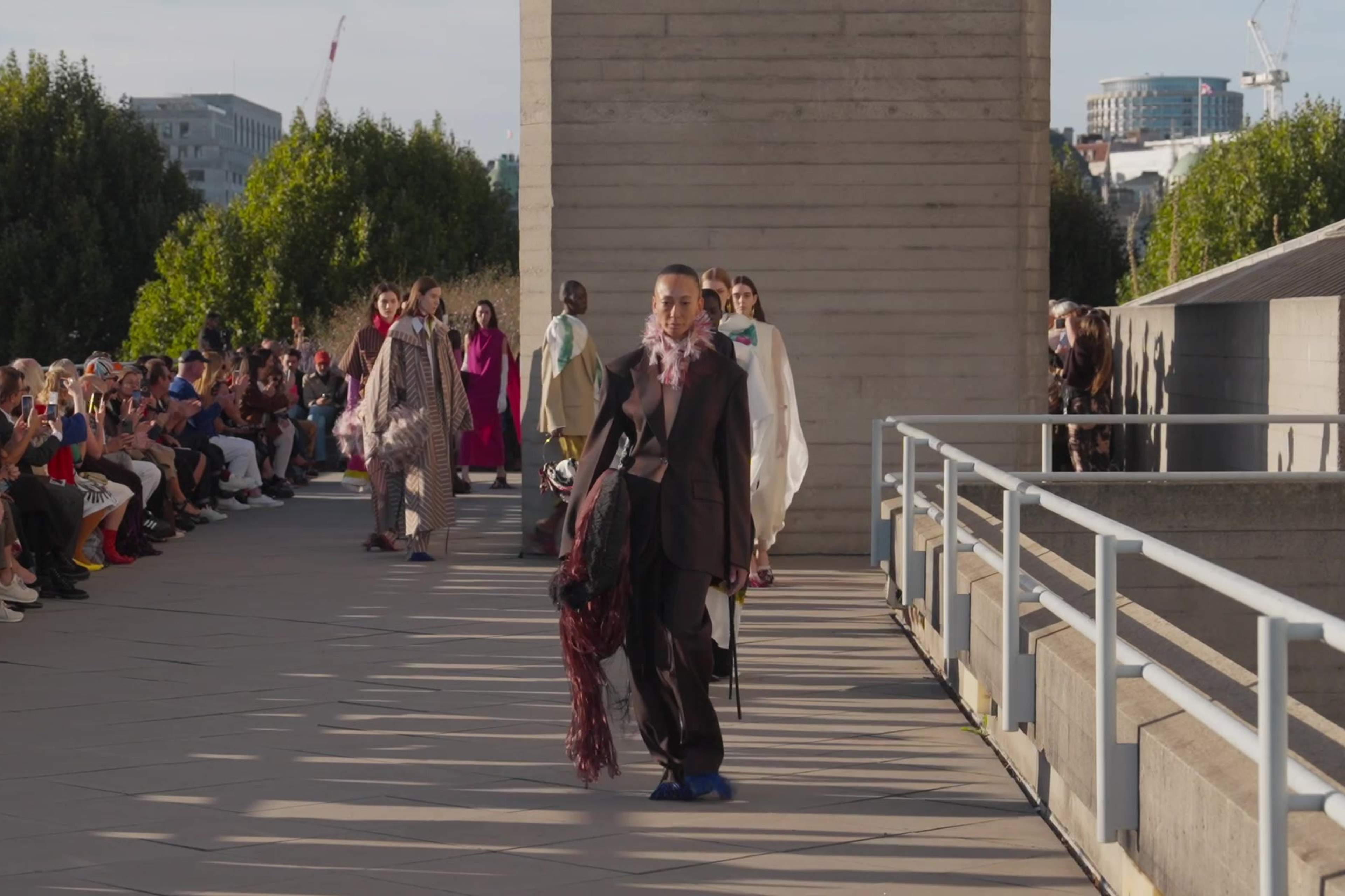 Models walk the finale past guests seated along the runway at Roksanda's September 2026 show