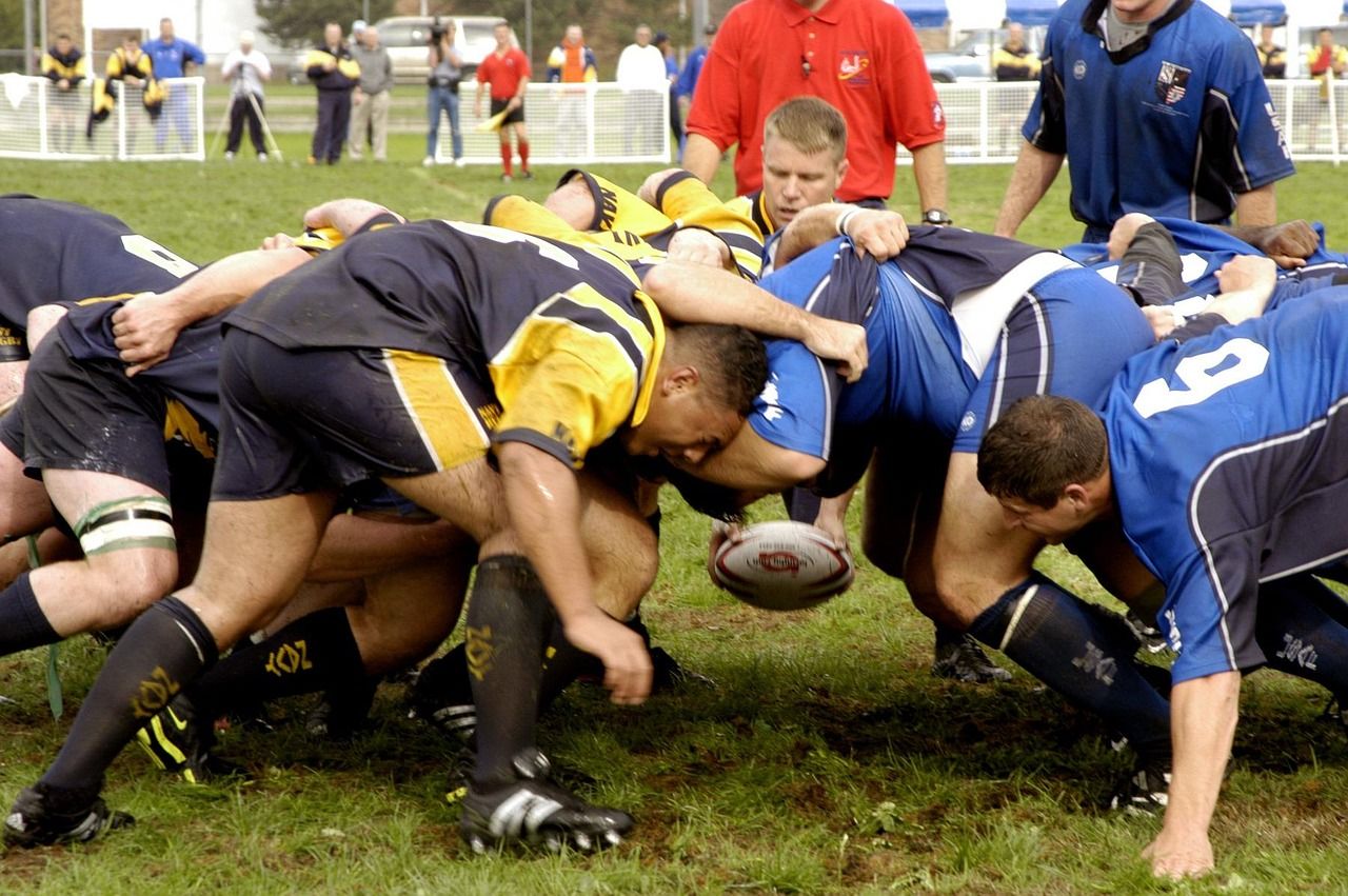 Rugby players in a fierce tackle, representing the intensity of early 20th century international rugby