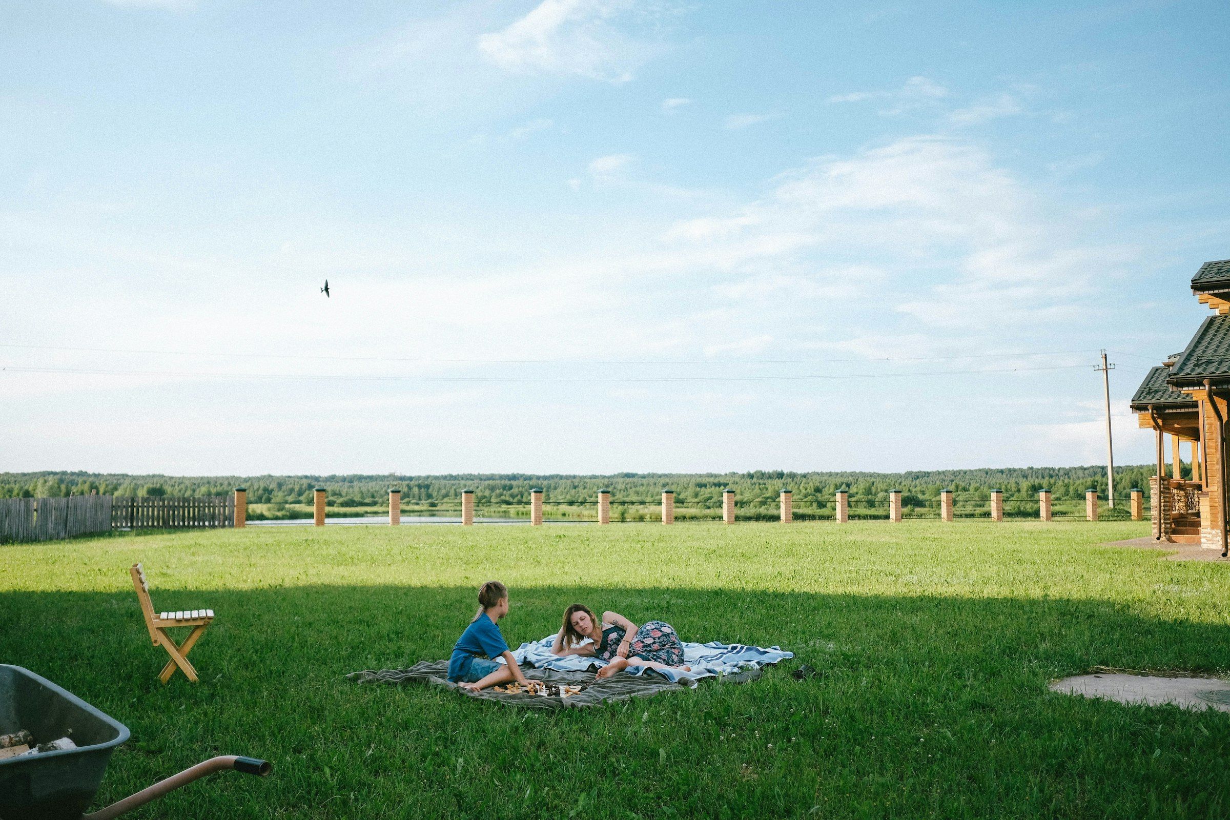 Glyndebourne Festival Opera (man and woman lying on green grass field during daytime)