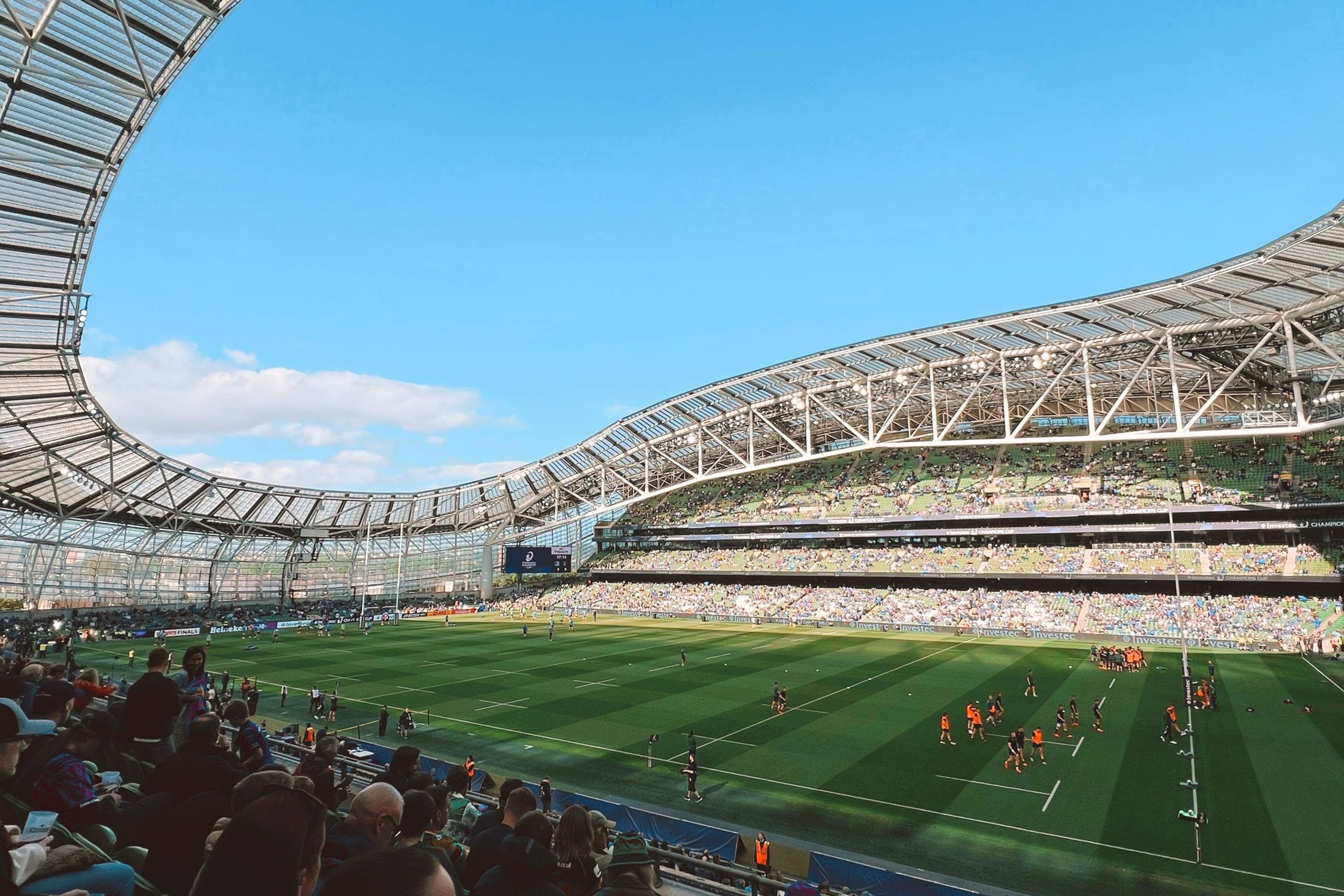 Aviva Stadium seen from the stands on a match day, looking across the pitch to the far stand under the curved roof
