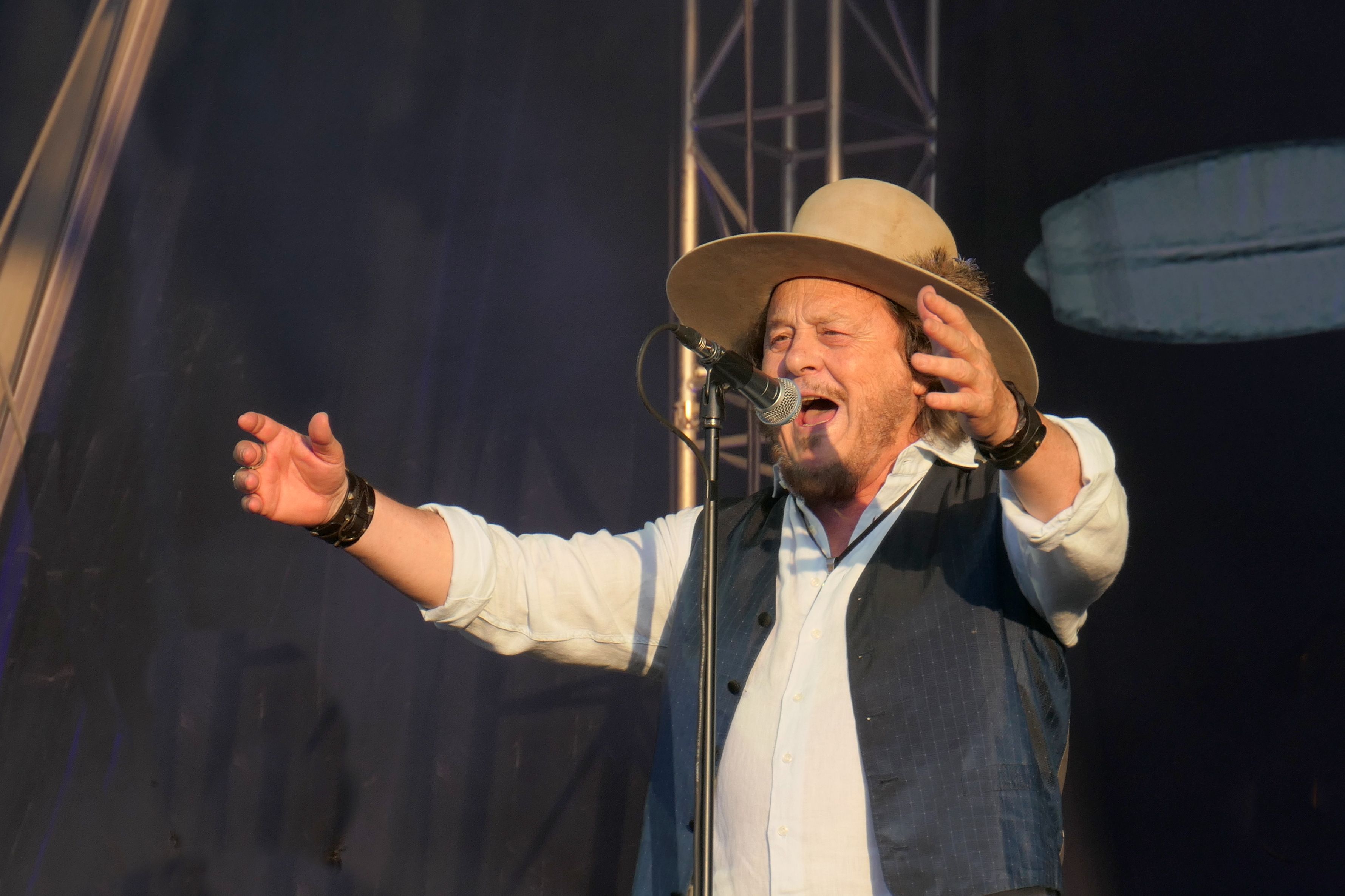 Zucchero Fornaciari singing at the microphone, arms spread