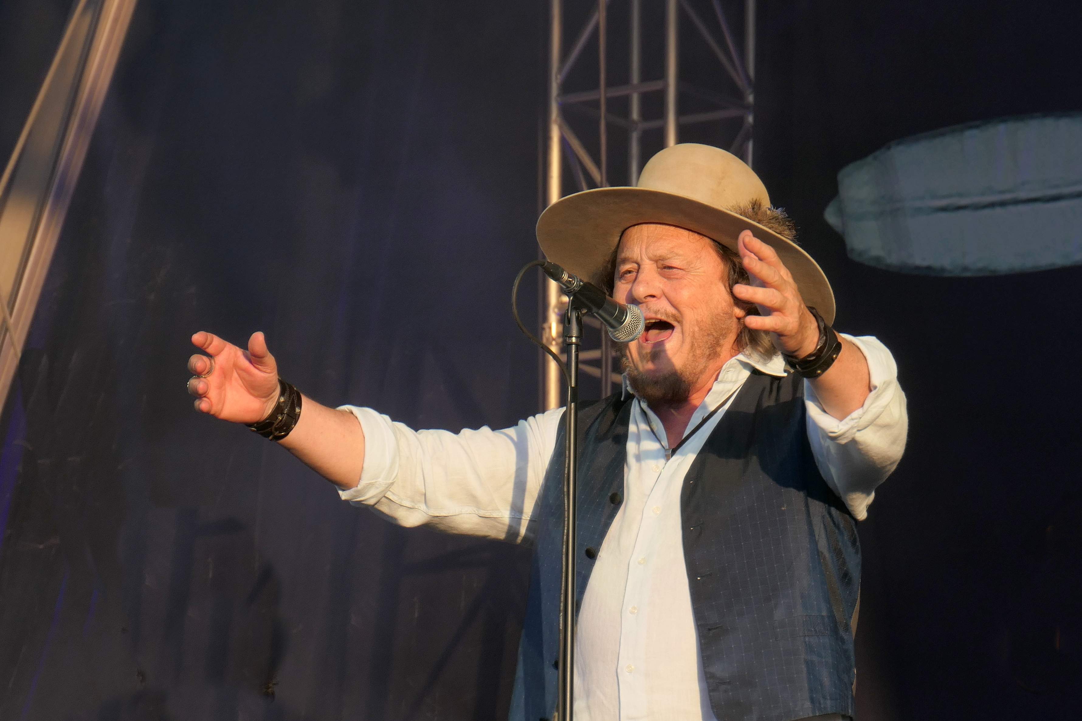 Zucchero Fornaciari singing at the microphone, arms spread