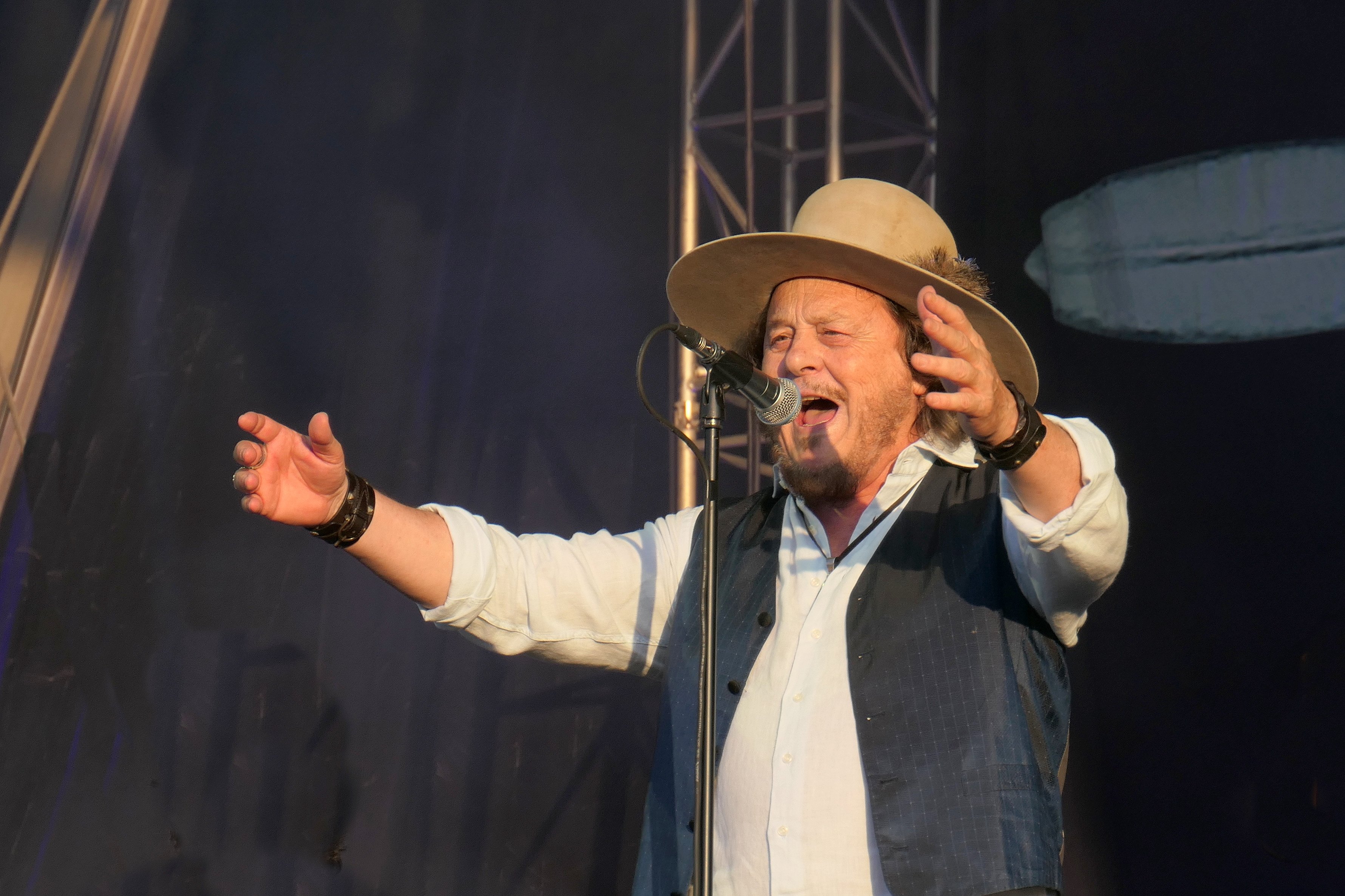 Zucchero Fornaciari singing at the microphone, arms spread