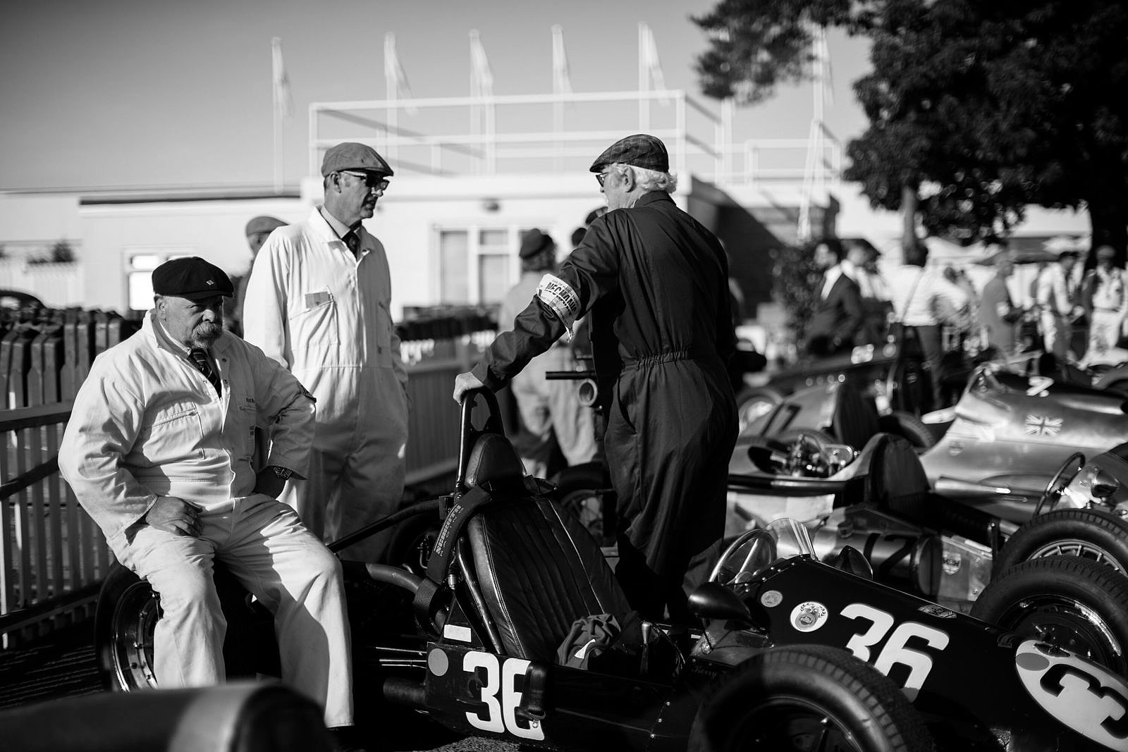 Vintage single-seater racing cars and drivers in the paddock at Goodwood Motor Circuit