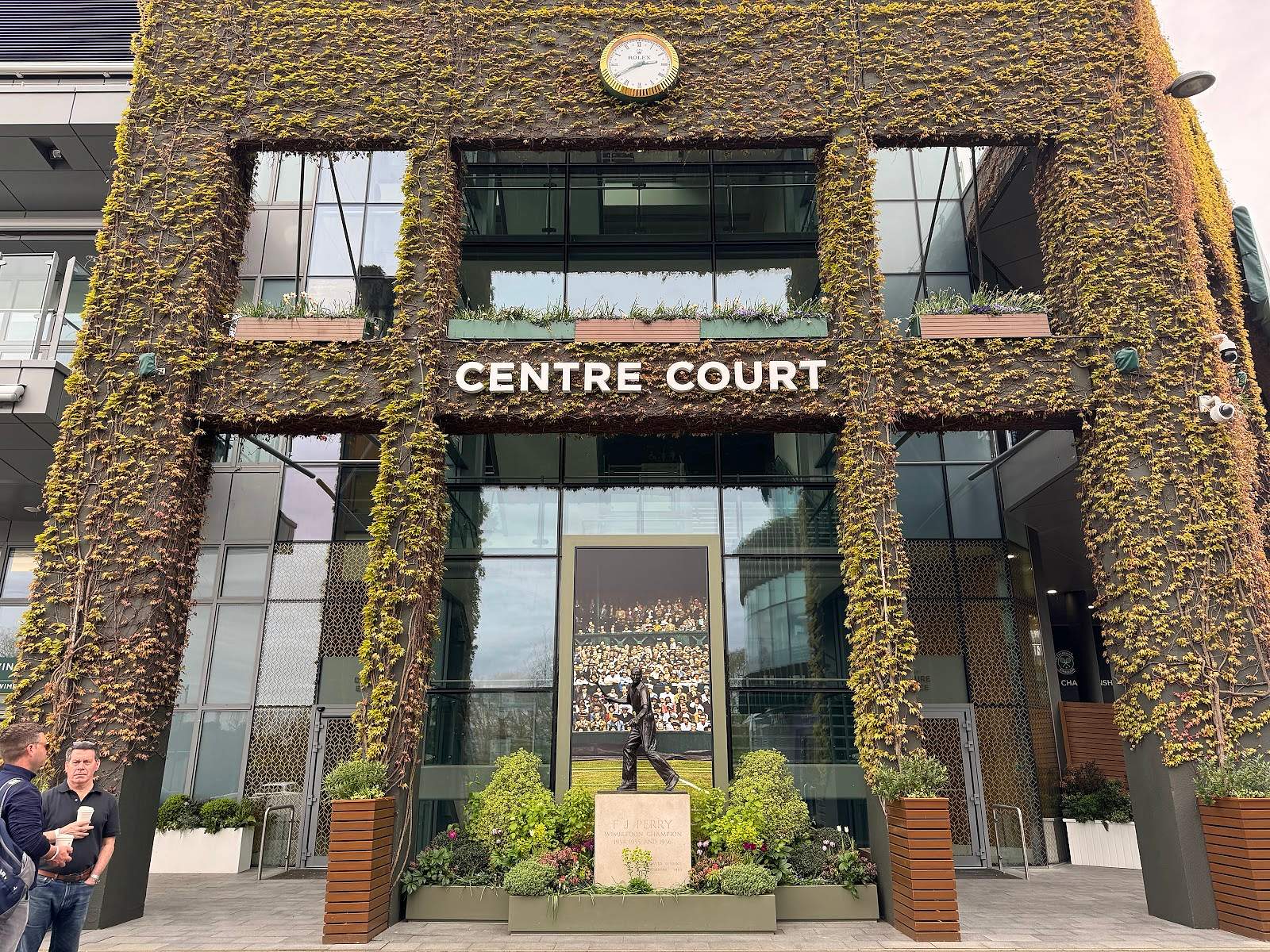 The ivy-clad Centre Court facade and Fred Perry statue at Wimbledon