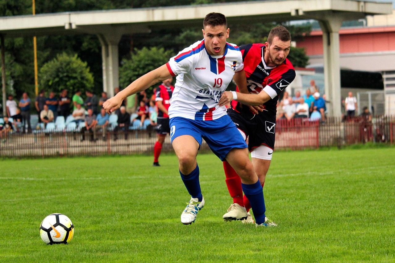 Football match action with players competing for the ball