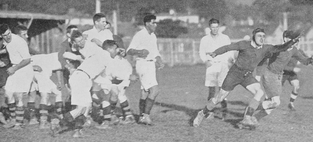 Vintage black and white photograph of a rugby scrum from the early 20th century