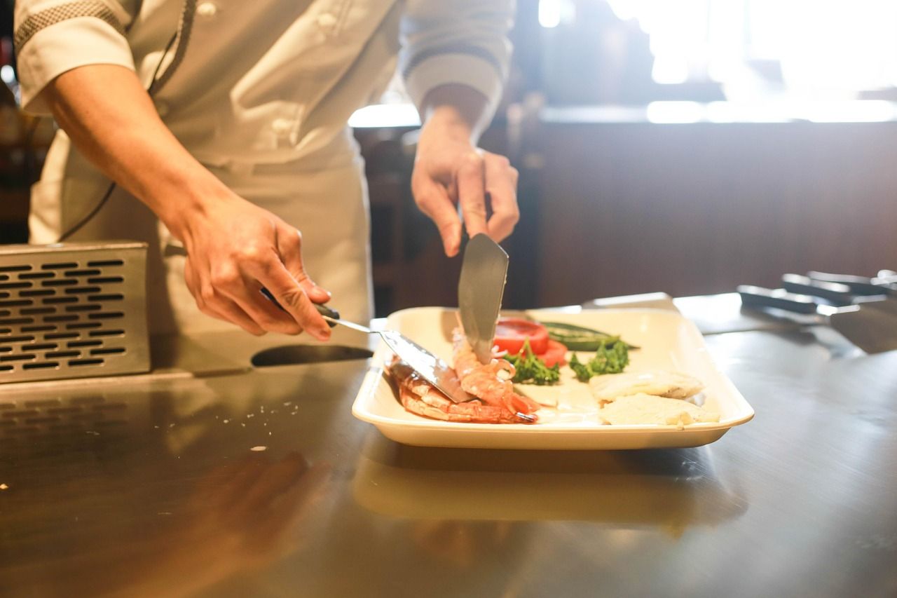 Chef carefully plating a dish in a Michelin-starred kitchen