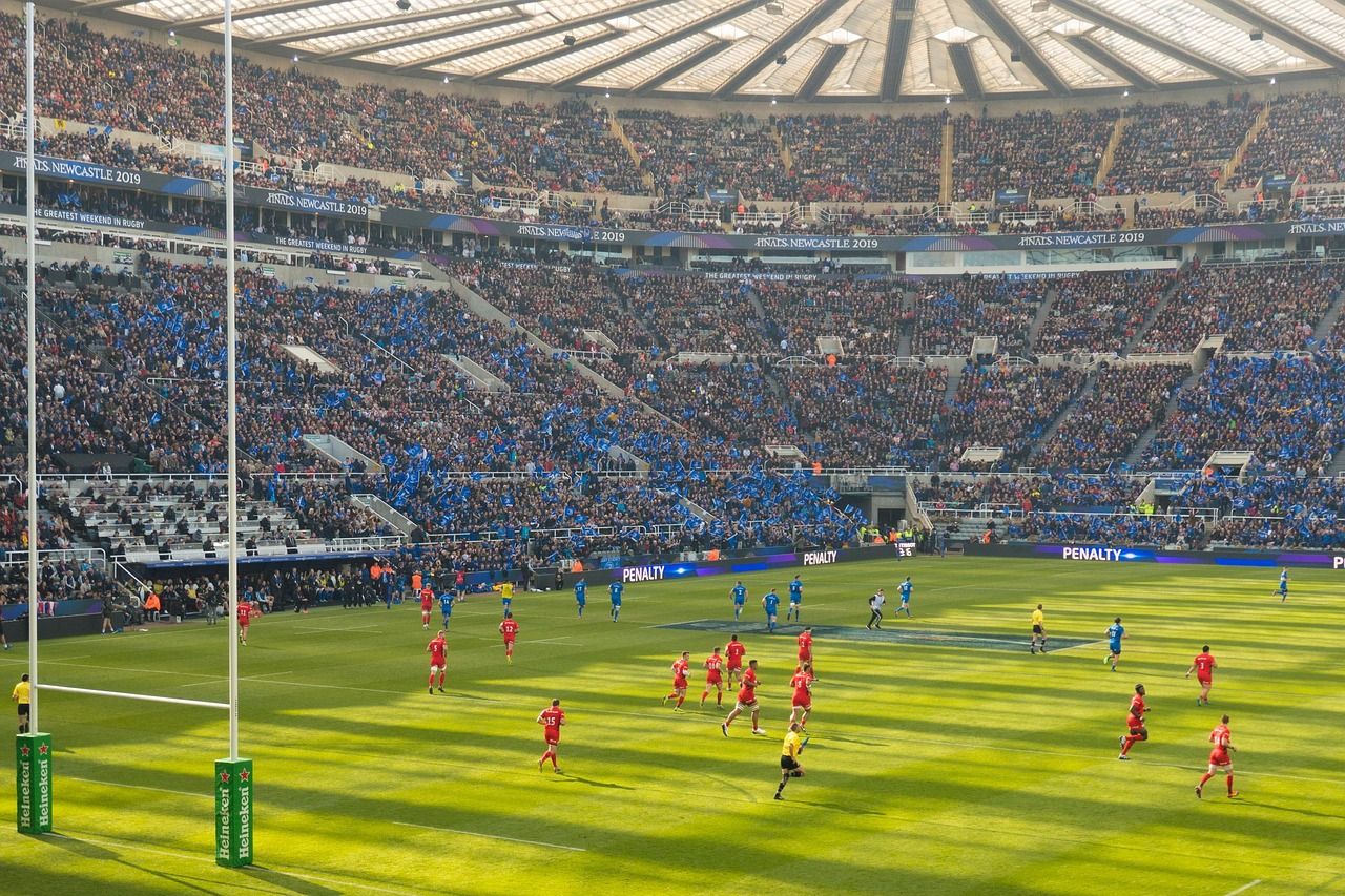 Rugby match action at a packed stadium, representing the intensity of the 2003 Grand Slam campaign