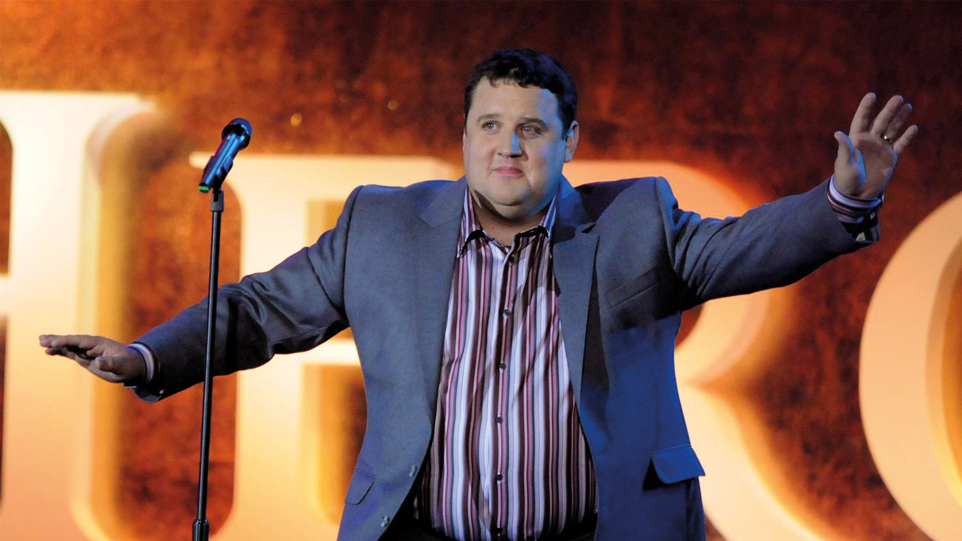 Stand-up comedy performance on a spotlit stage