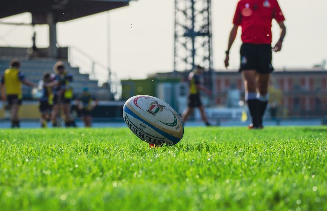 A rugby ball on a green pitch, symbolising the traditions of the game