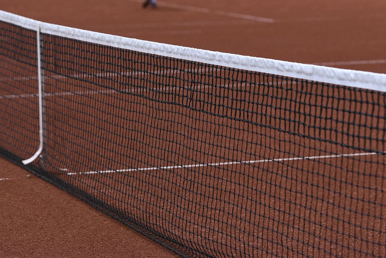 Tennis net detail on a clay court