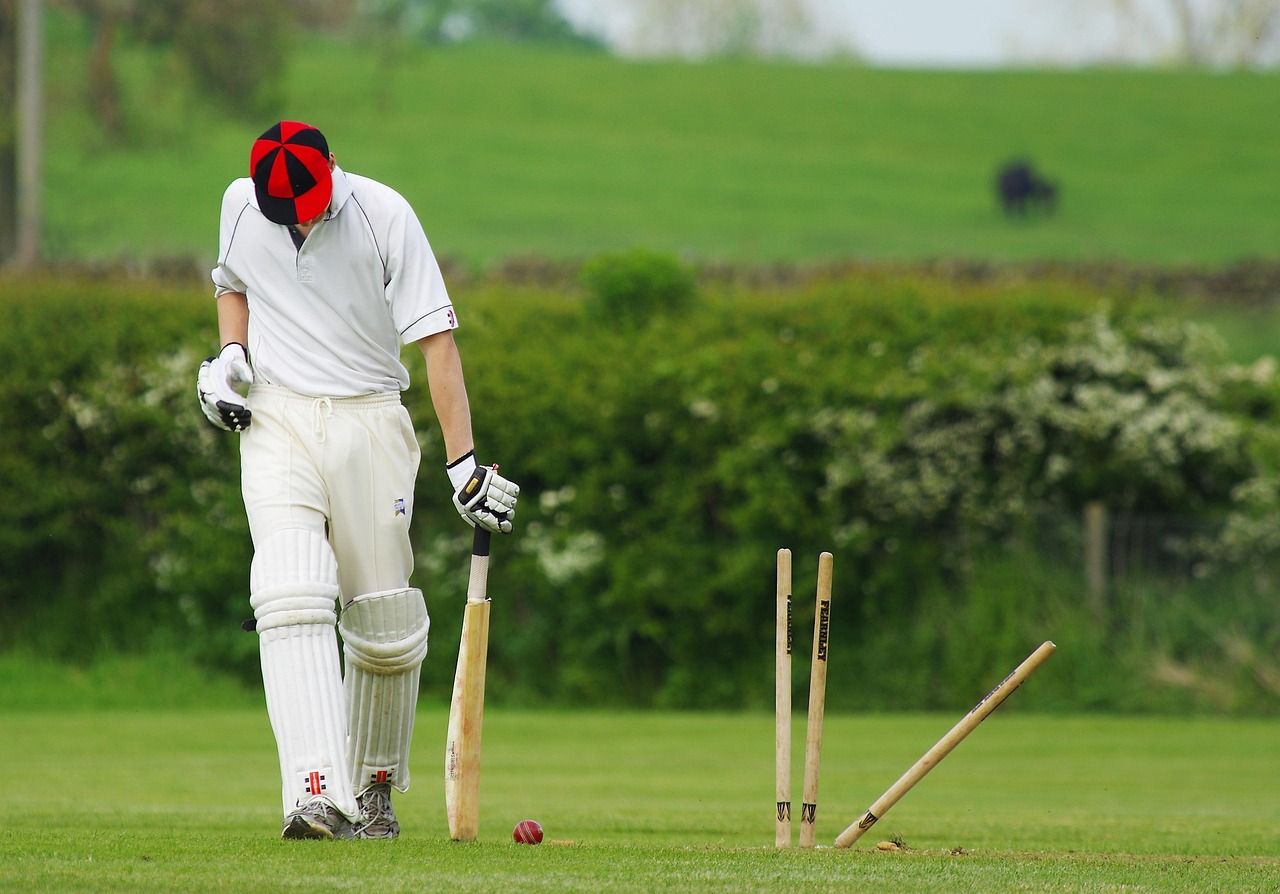 Cricket stumps shattered by a fast delivery, evoking the destructive pace of Waqar Younis