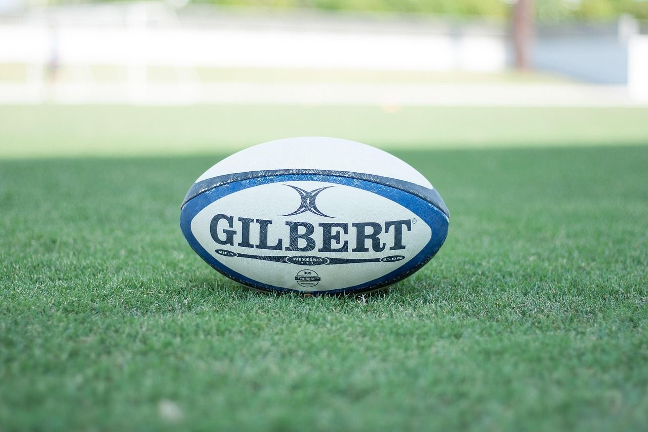 Rugby ball on a grass pitch, symbolising the sport that would become central to Nordoff Robbins fundraising