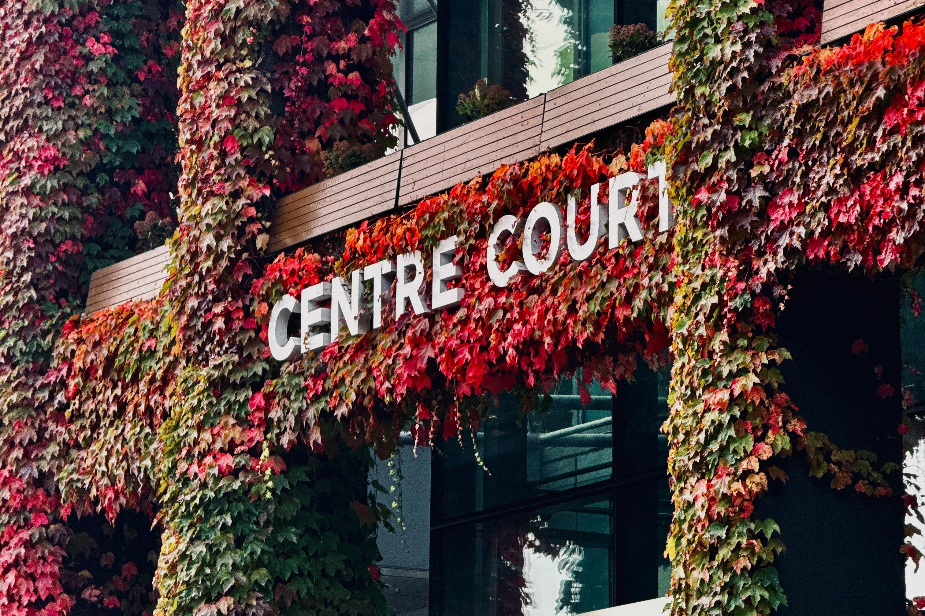 The ivy-clad exterior of Centre Court at the All England Lawn Tennis Club, Wimbledon, with its Centre Court signage