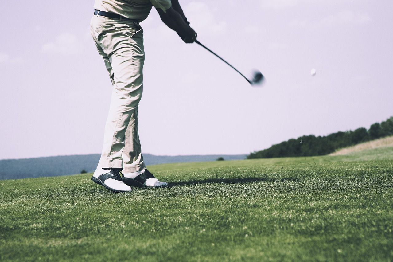Golfer teeing off on a championship course, evoking the early days of the Ryder Cup