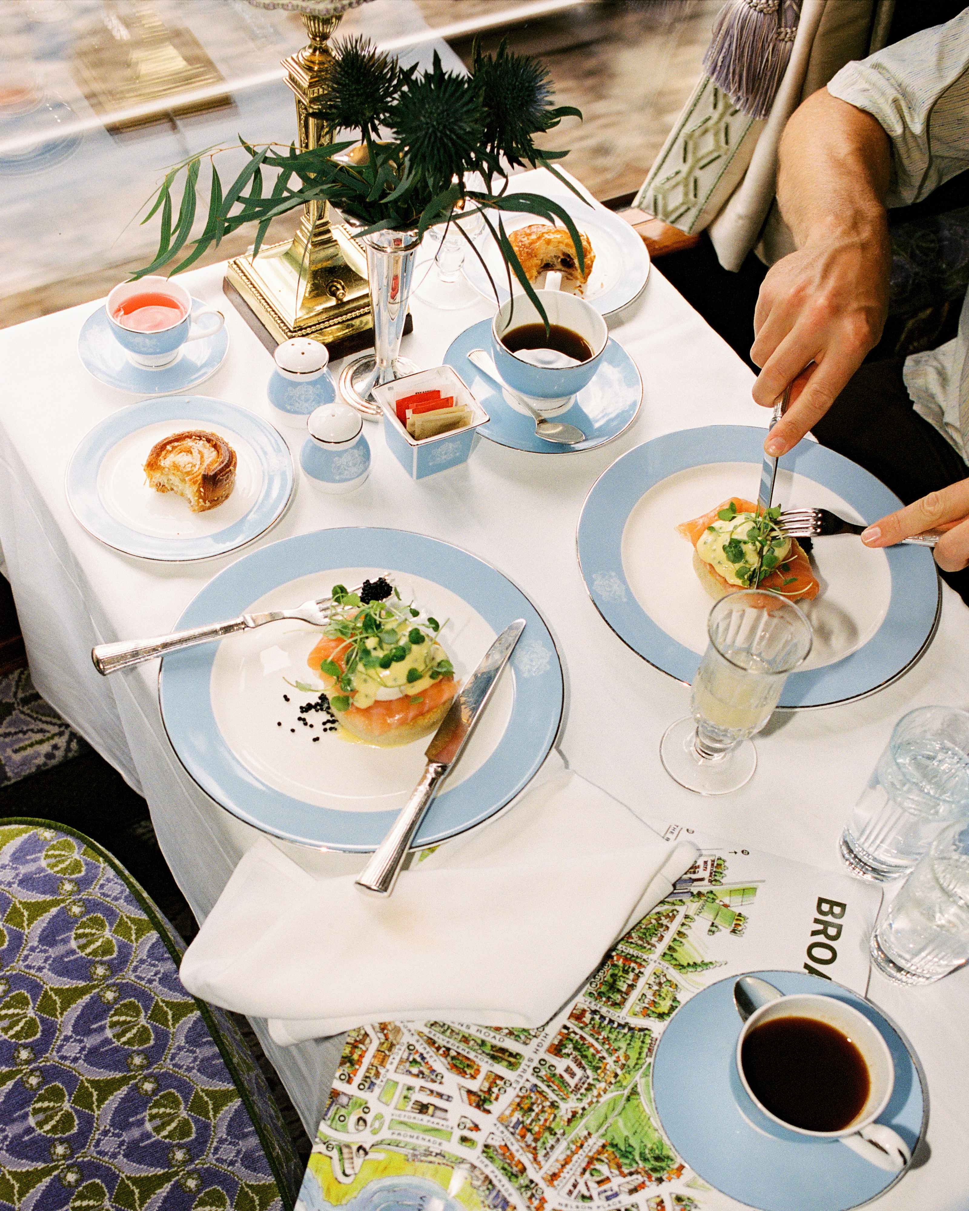 Brunch laid out with poached eggs, salmon, coffee and pastries