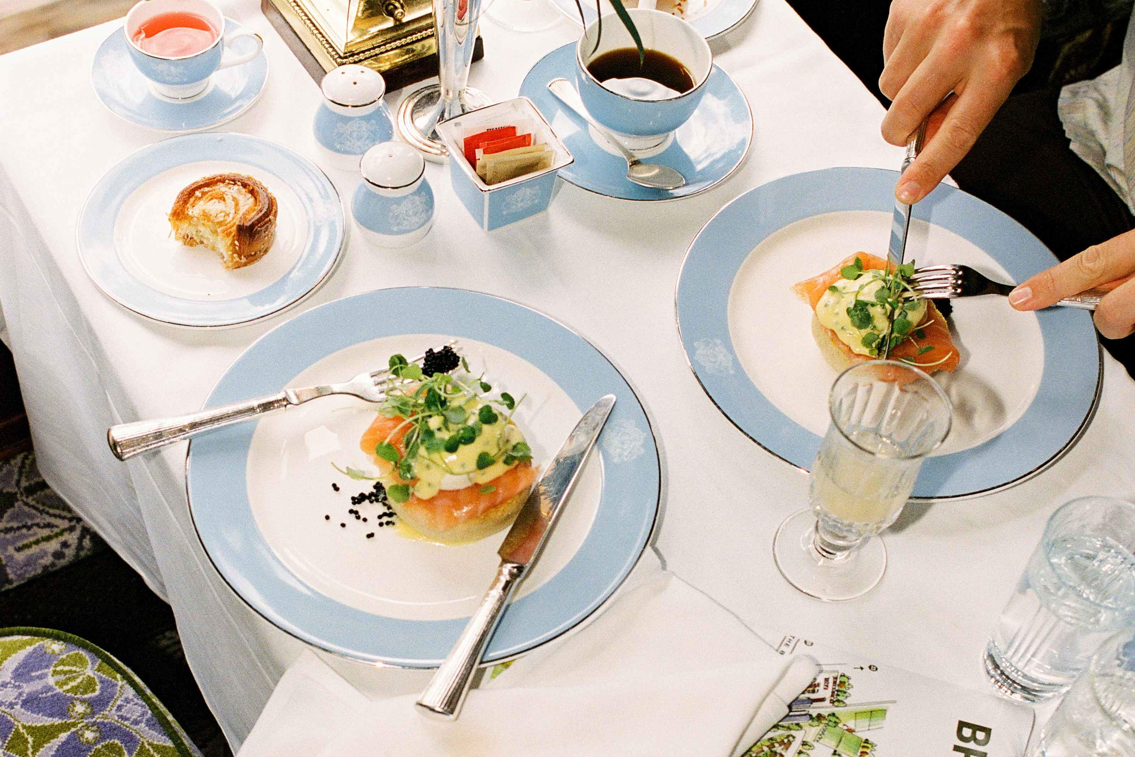 Brunch laid out with poached eggs, salmon, coffee and pastries