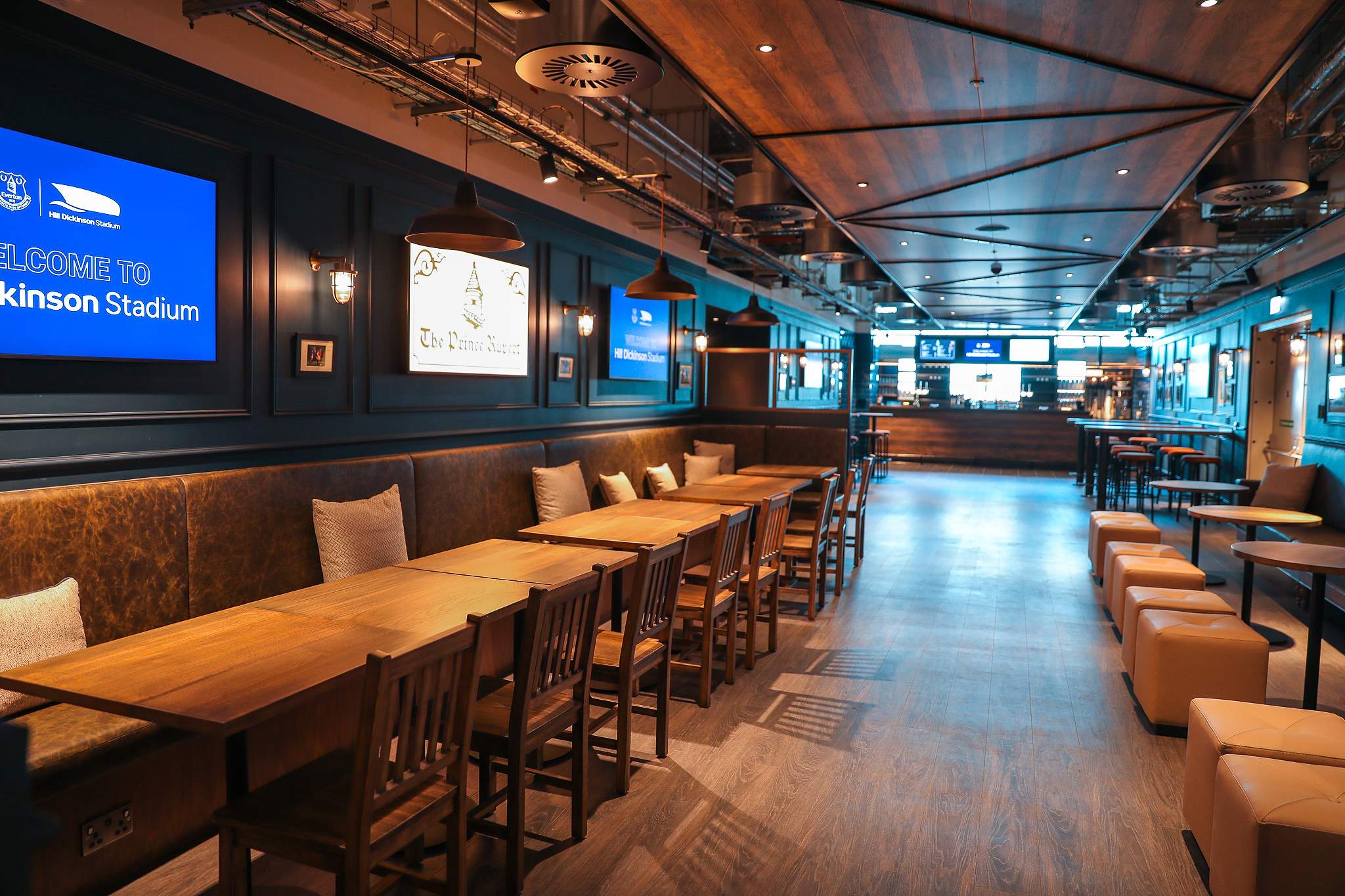 Village Street, Hill Dickinson Stadium: The Prince Rupert pub interior, banquette seating and illuminated pub sign, bar at far end