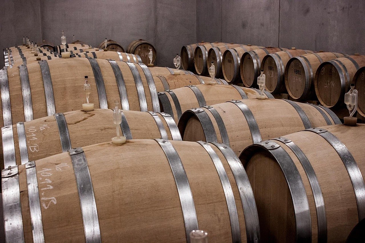Wine barrels stacked in a traditional Bordeaux cellar