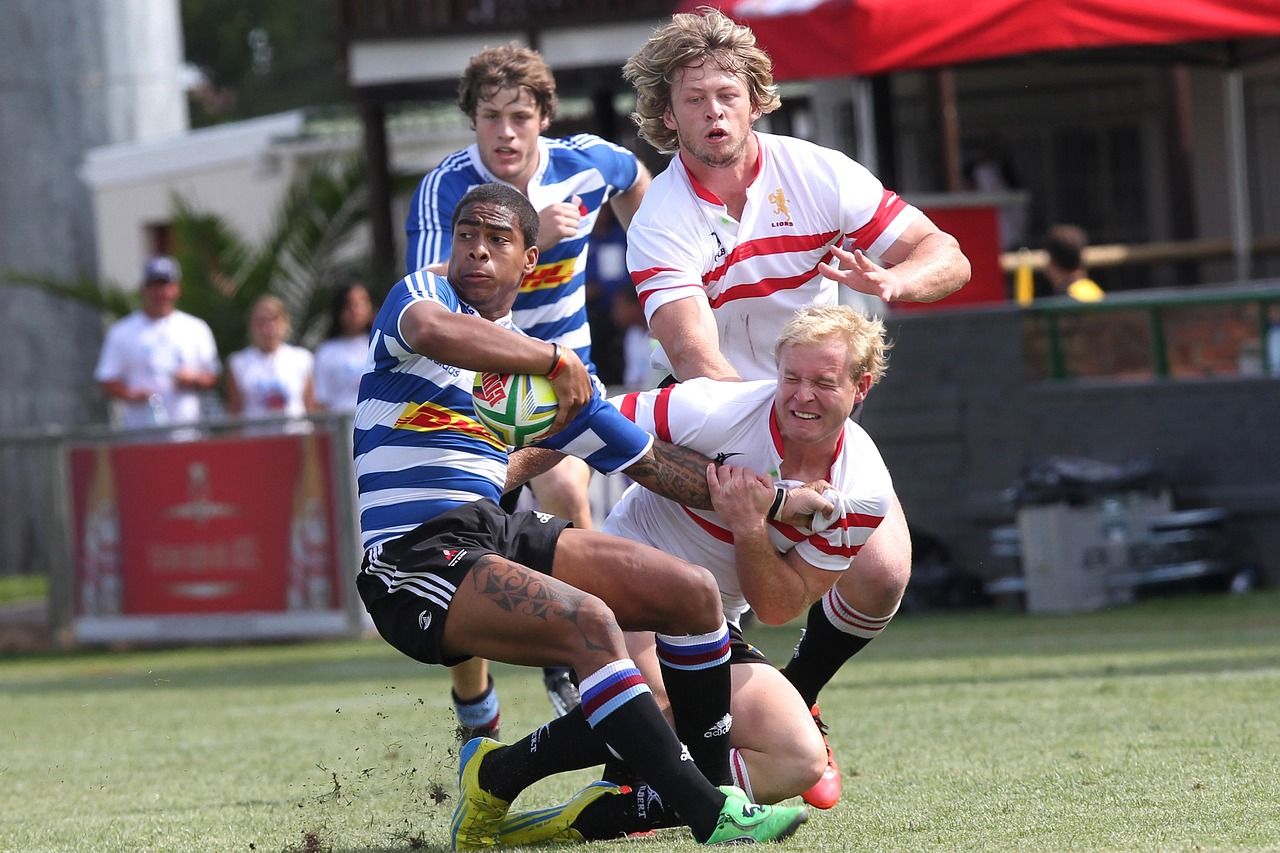 Rugby players in close contact during a tackle