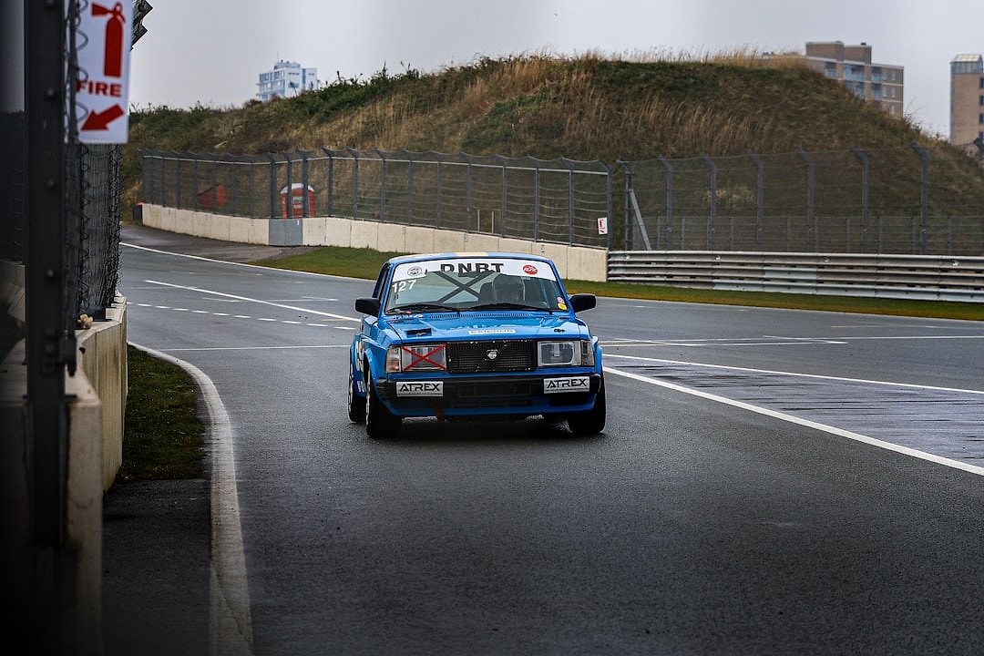 A car navigating the banked turn at the redeveloped Circuit Zandvoort