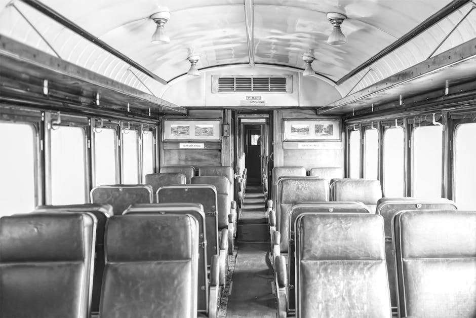 Interior of a vintage train carriage with leather seats, evoking the golden age of rail travel