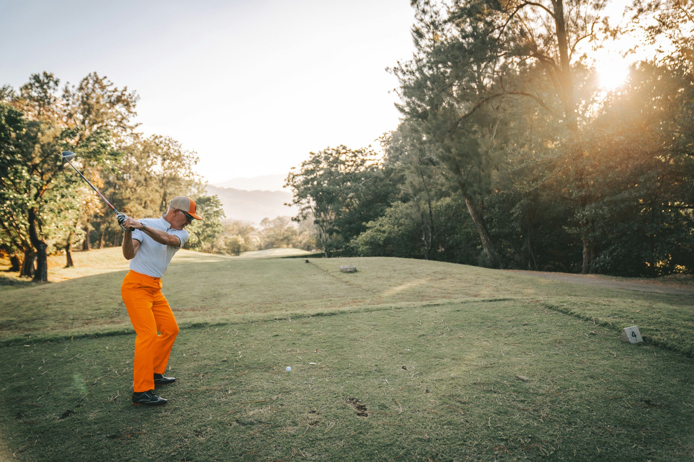 Ryder Cup-style golf scene (a man swinging a golf club on a golf course)