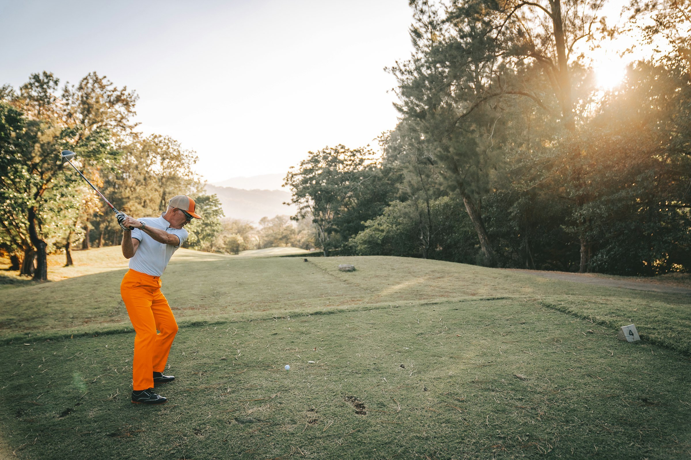 Ryder Cup-style golf scene (a man swinging a golf club on a golf course)
