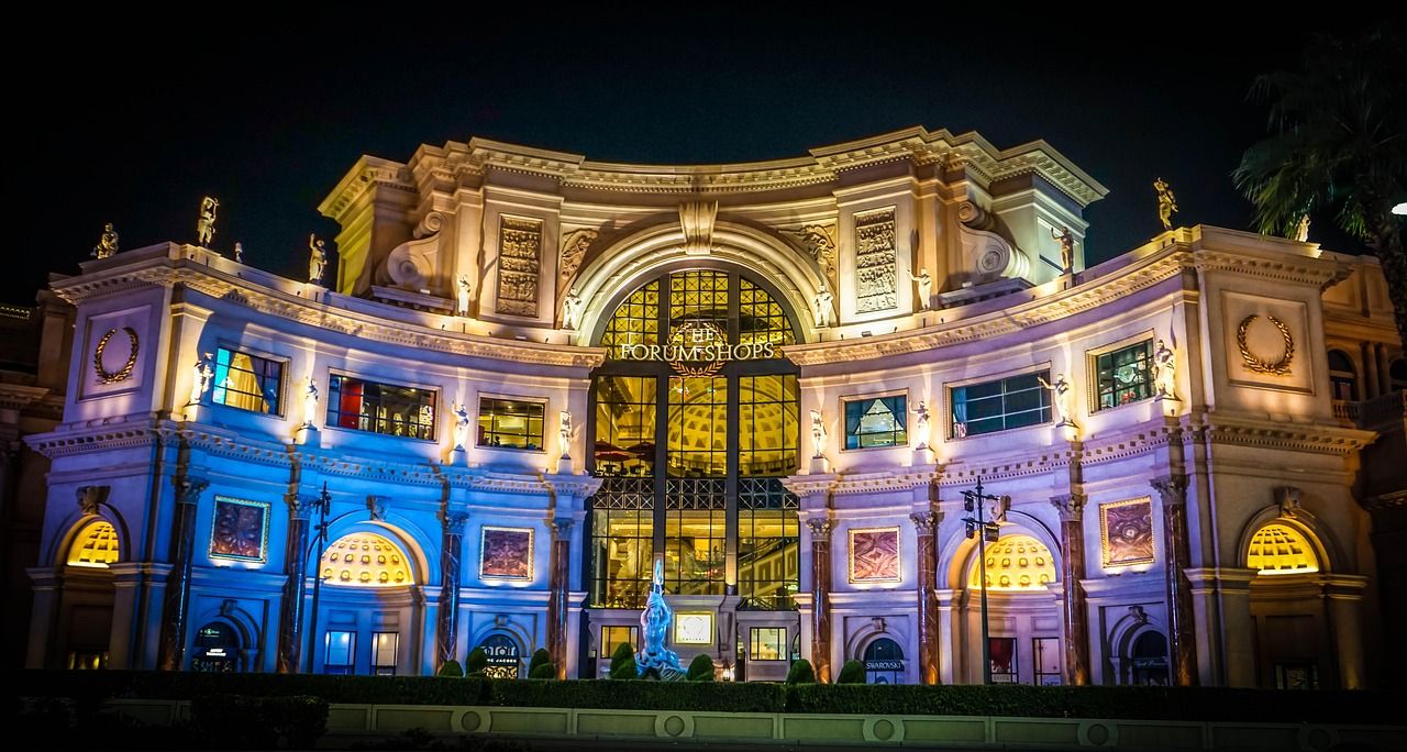 Caesars Palace Las Vegas illuminated at night with reflection in water