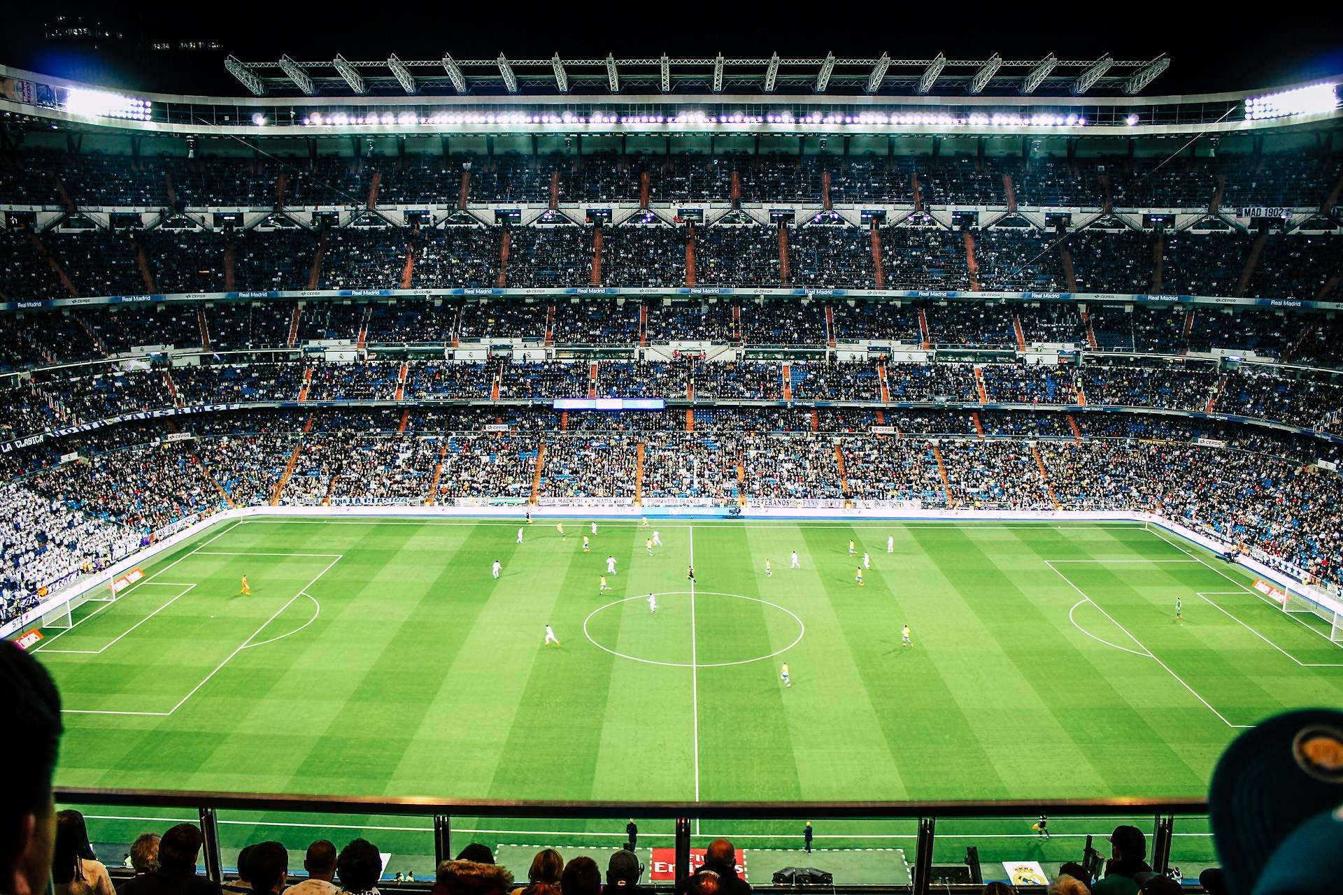 Football match action in a packed stadium
