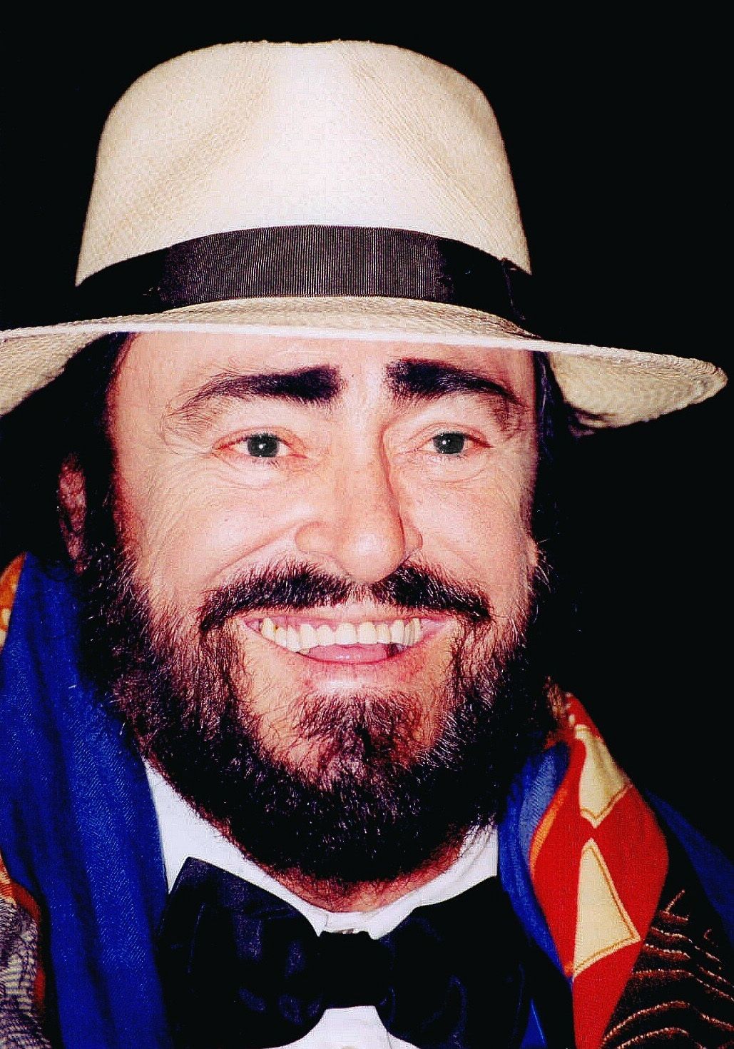 Luciano Pavarotti in a panama hat, smiling
