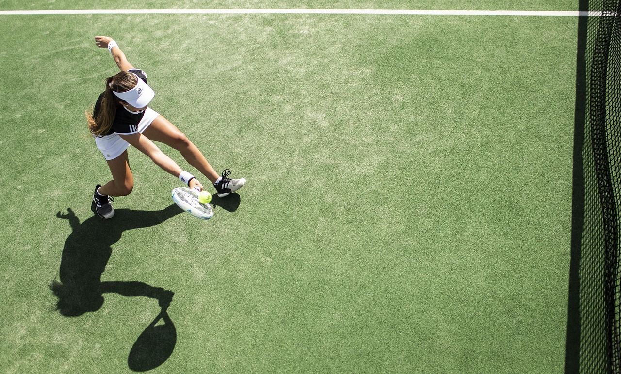 Tennis player in action, representing the introduction of women's competition at Wimbledon