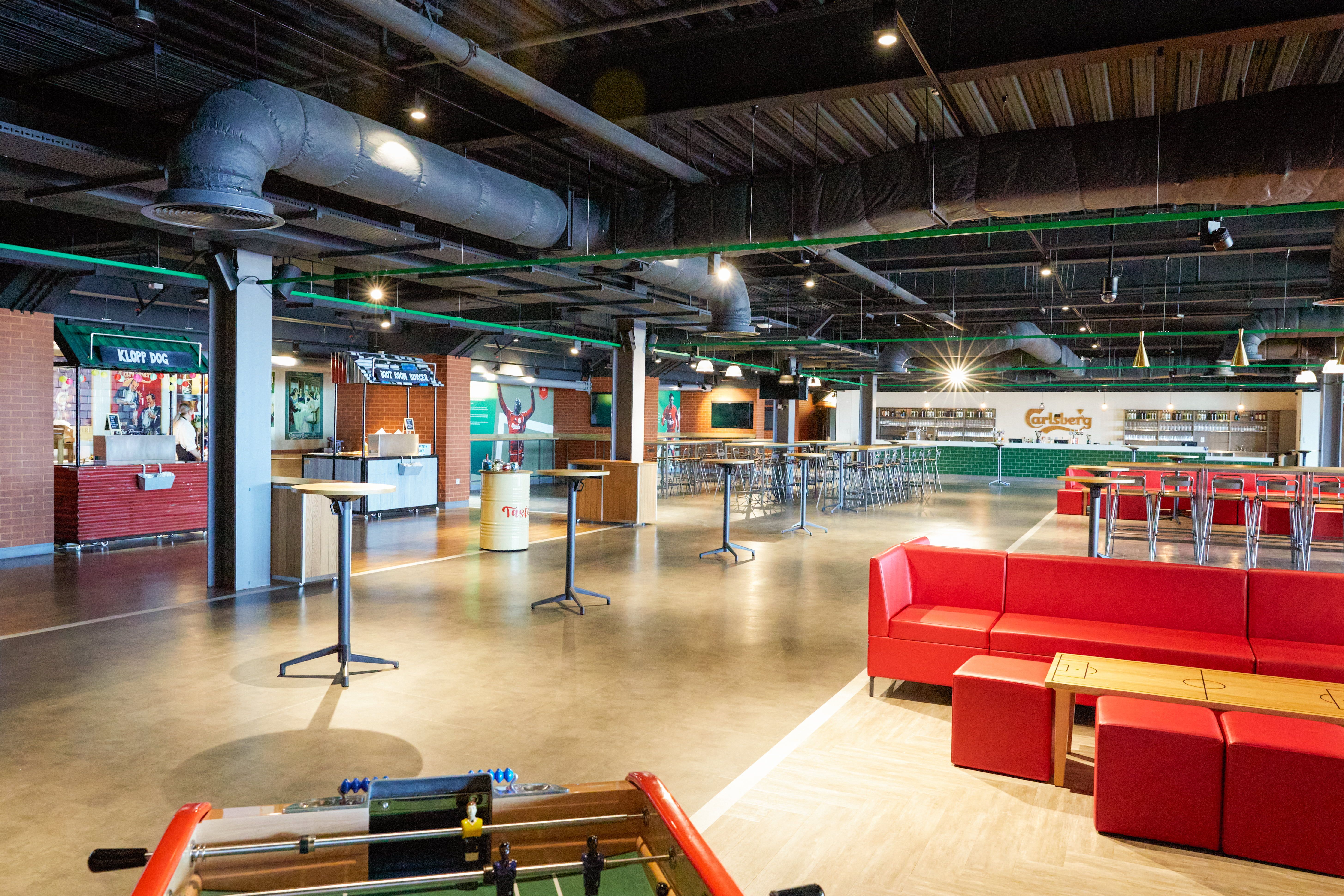 The Carlsberg Dugout, Anfield: Carlsberg Dugout lounge, Klopp Dog street-food stall, red sofas and foosball table
