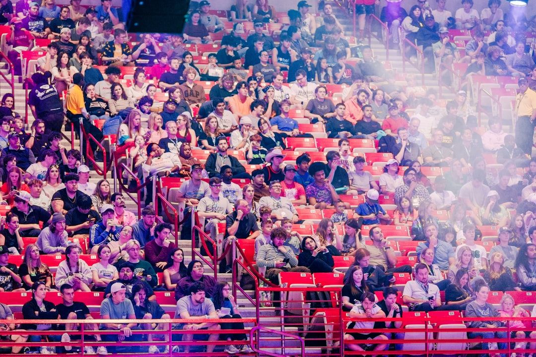 A large seated crowd filling an arena for a live show