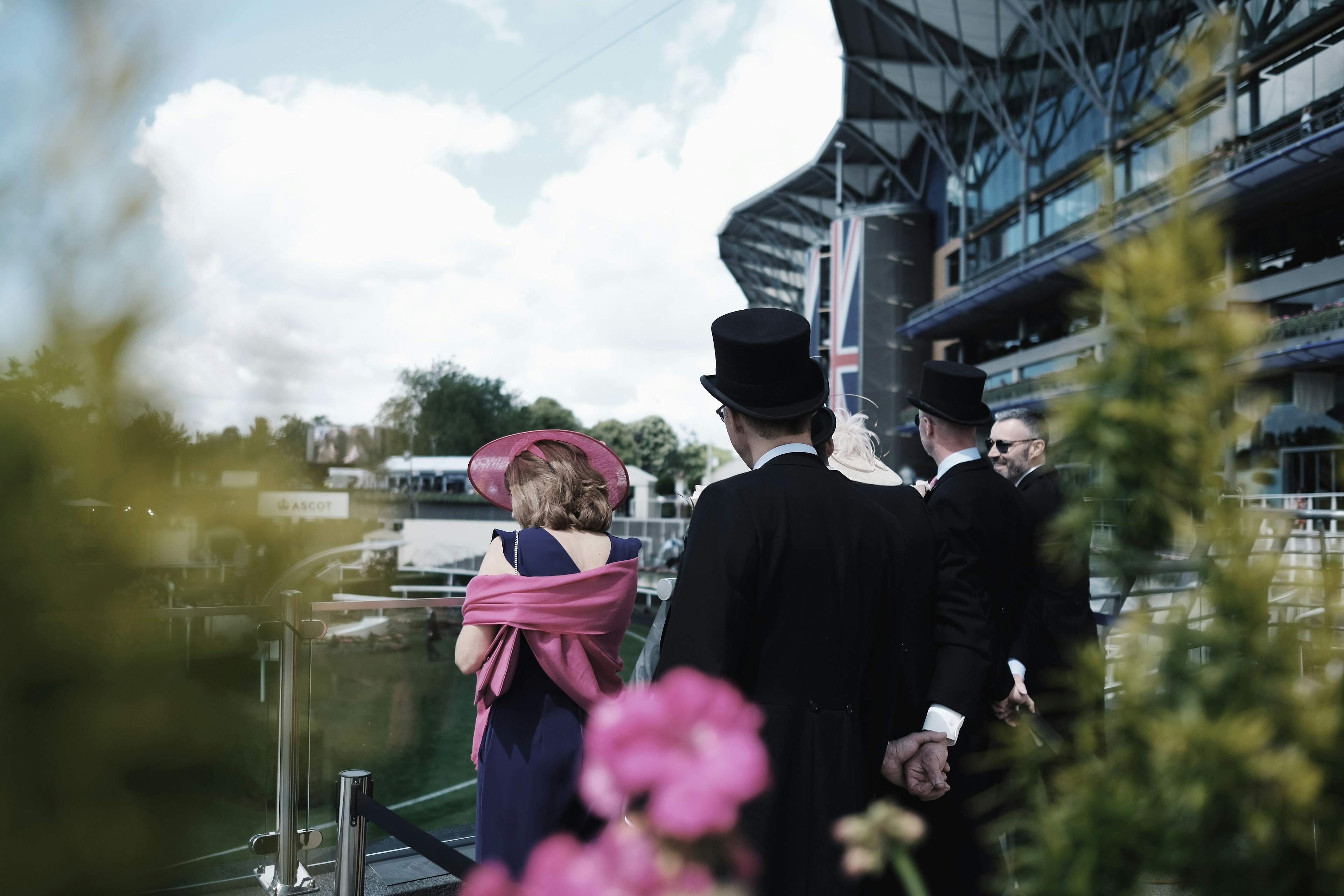 Smartly-dressed men and women in the audience at Royal Ascot
