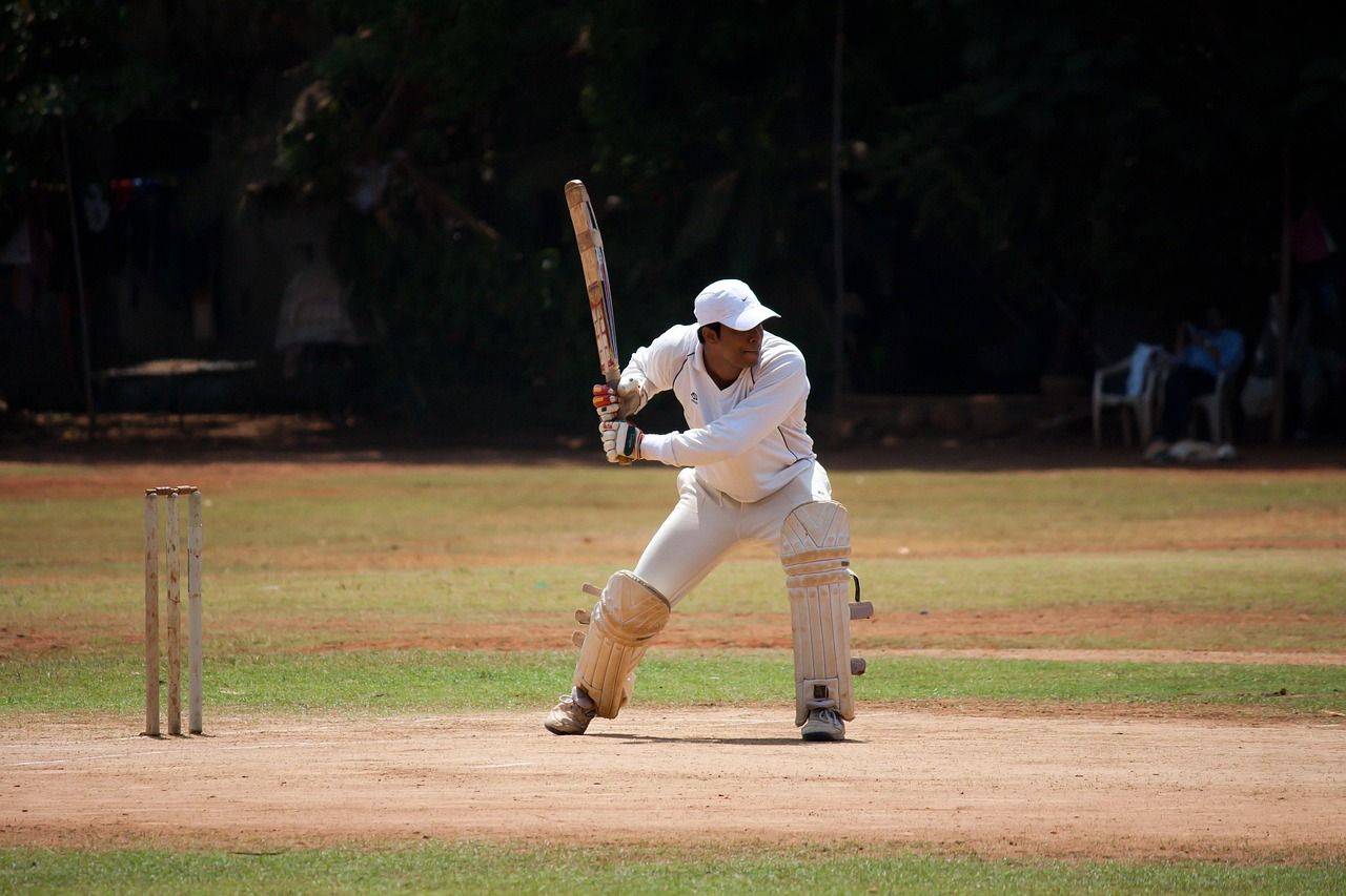 A batsman hitting the ball during a cricket match