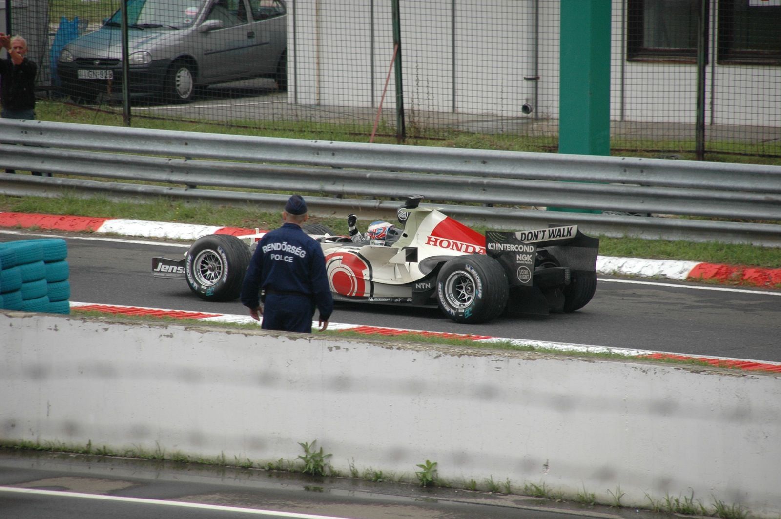 Formula 1 car driving on a wet track surface