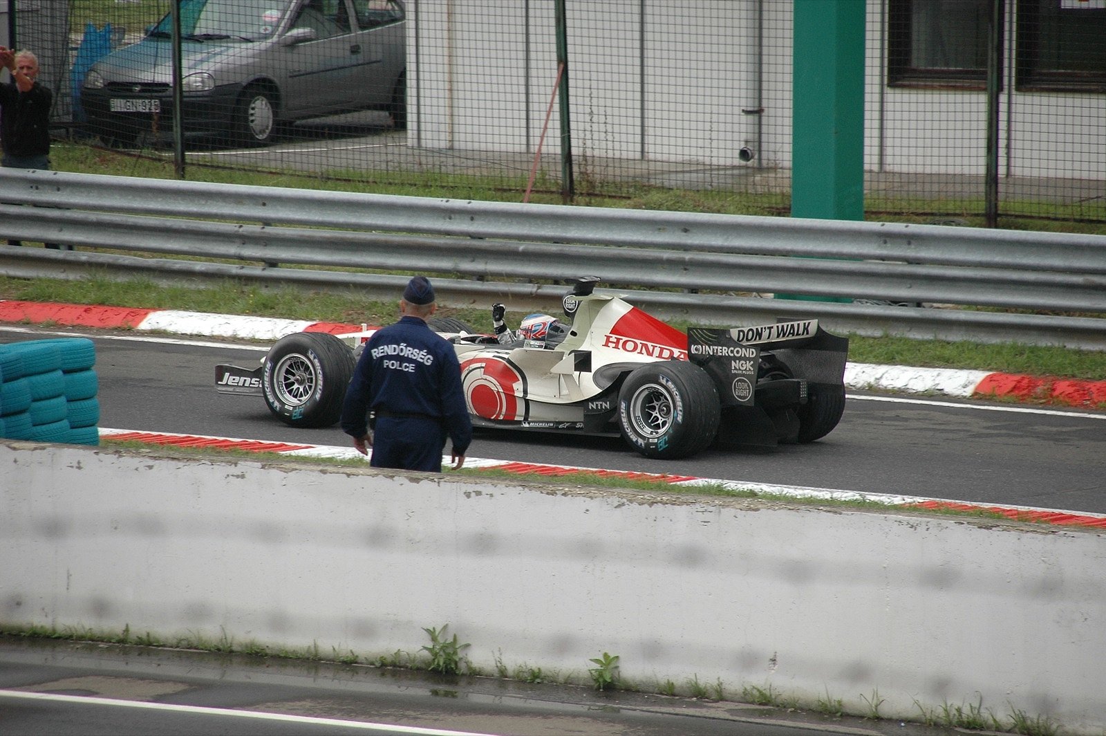 Formula 1 car driving on a wet track surface