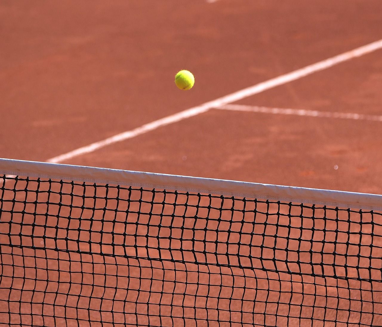 Tennis net on a clay court, symbolising the Open Era of professional tennis
