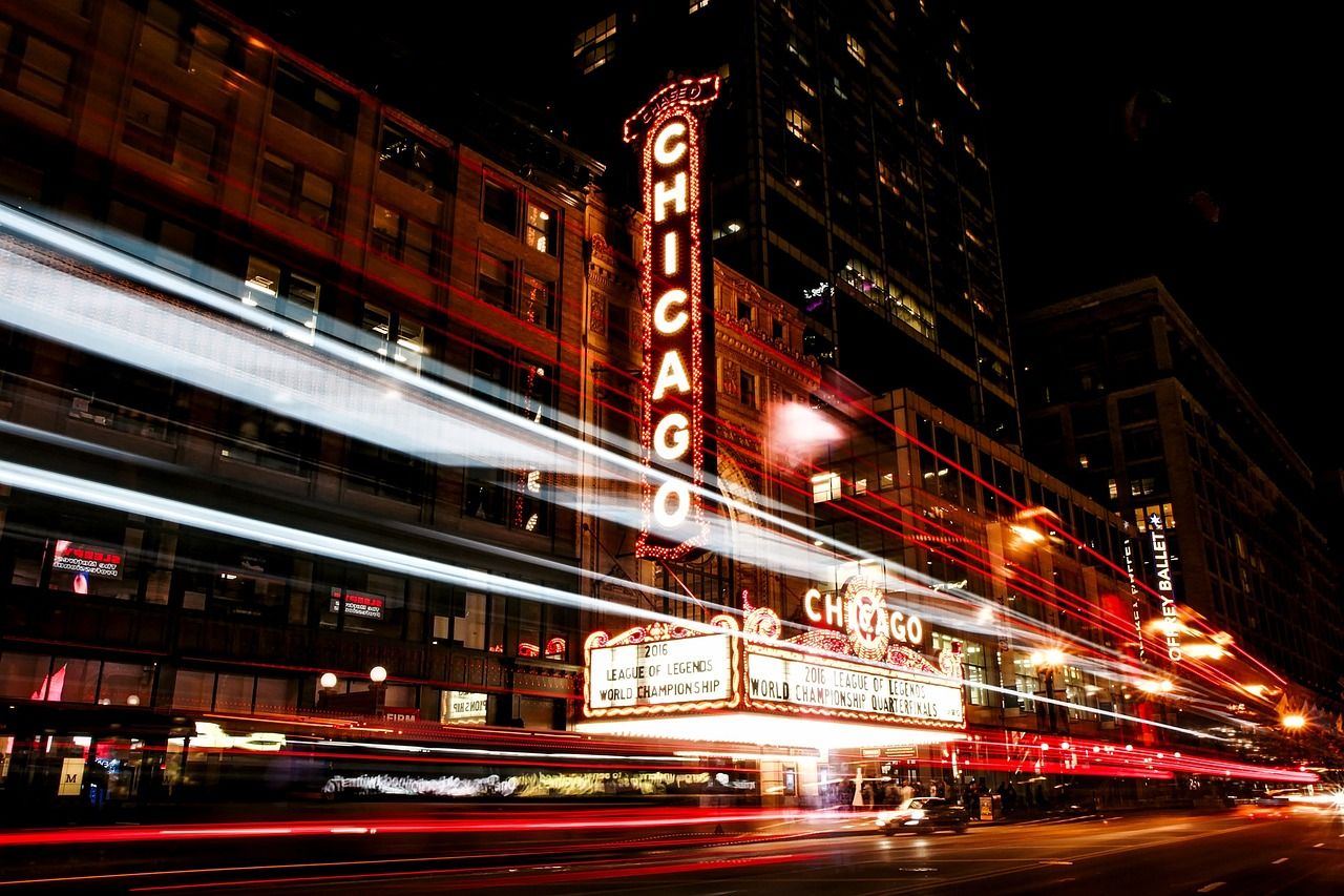 Chicago Theatre at night with neon signs, near the venue of The Devil Wears Prada's world premiere