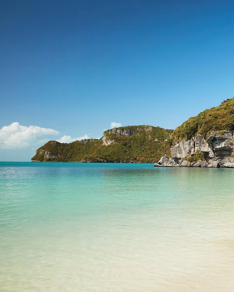Turquoise water and forested limestone islands off the coast of Langkawi, Malaysia.