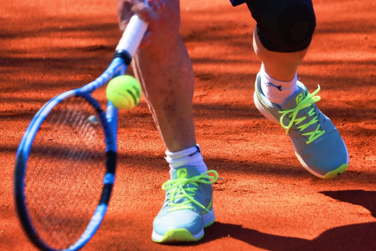 Tennis player's shoes on clay court surface, the battlefield of Roland Garros