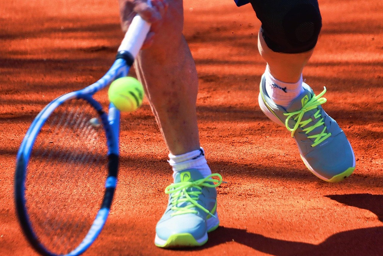 Tennis player's shoes on clay court surface, the battlefield of Roland Garros
