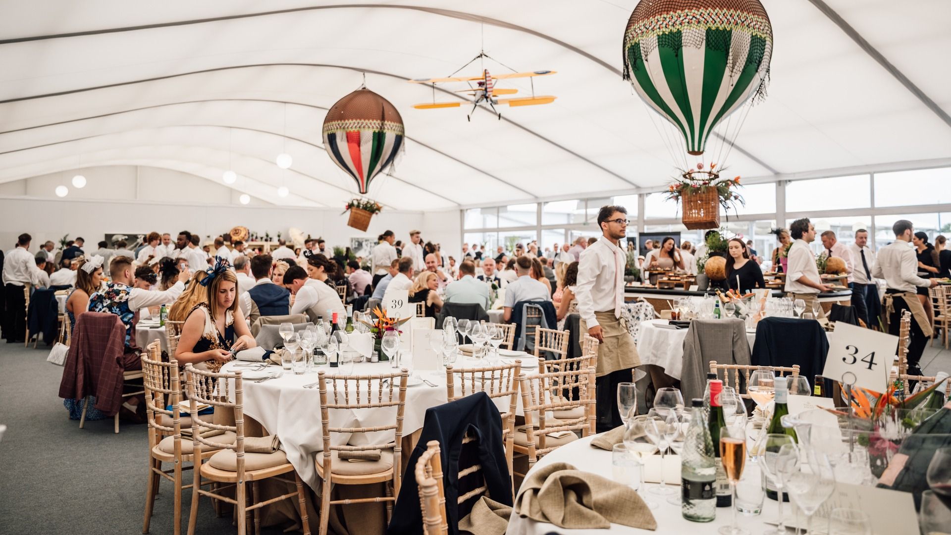 Guests dining inside a marquee at Royal Ascot's Village Enclosure