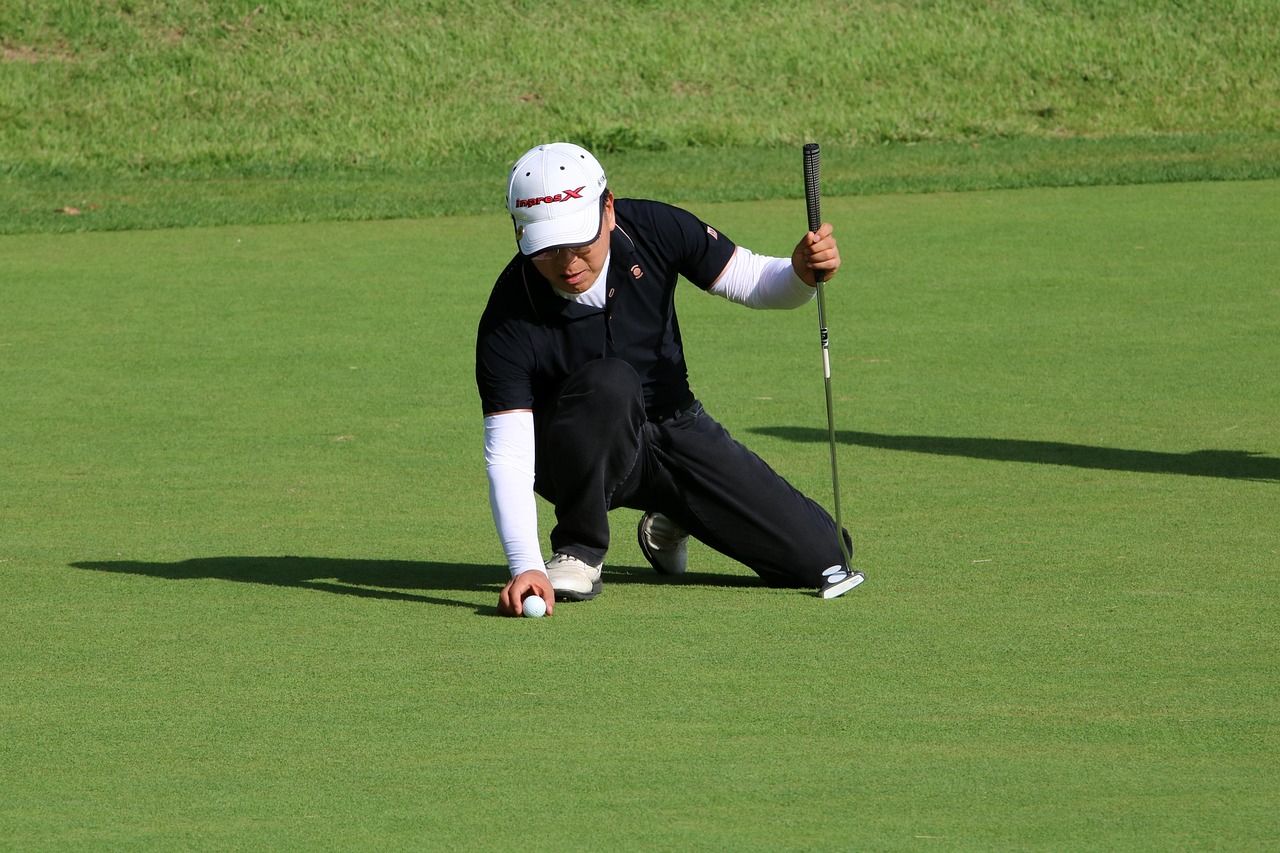 Golfer putting on a tournament green with spectators in the background