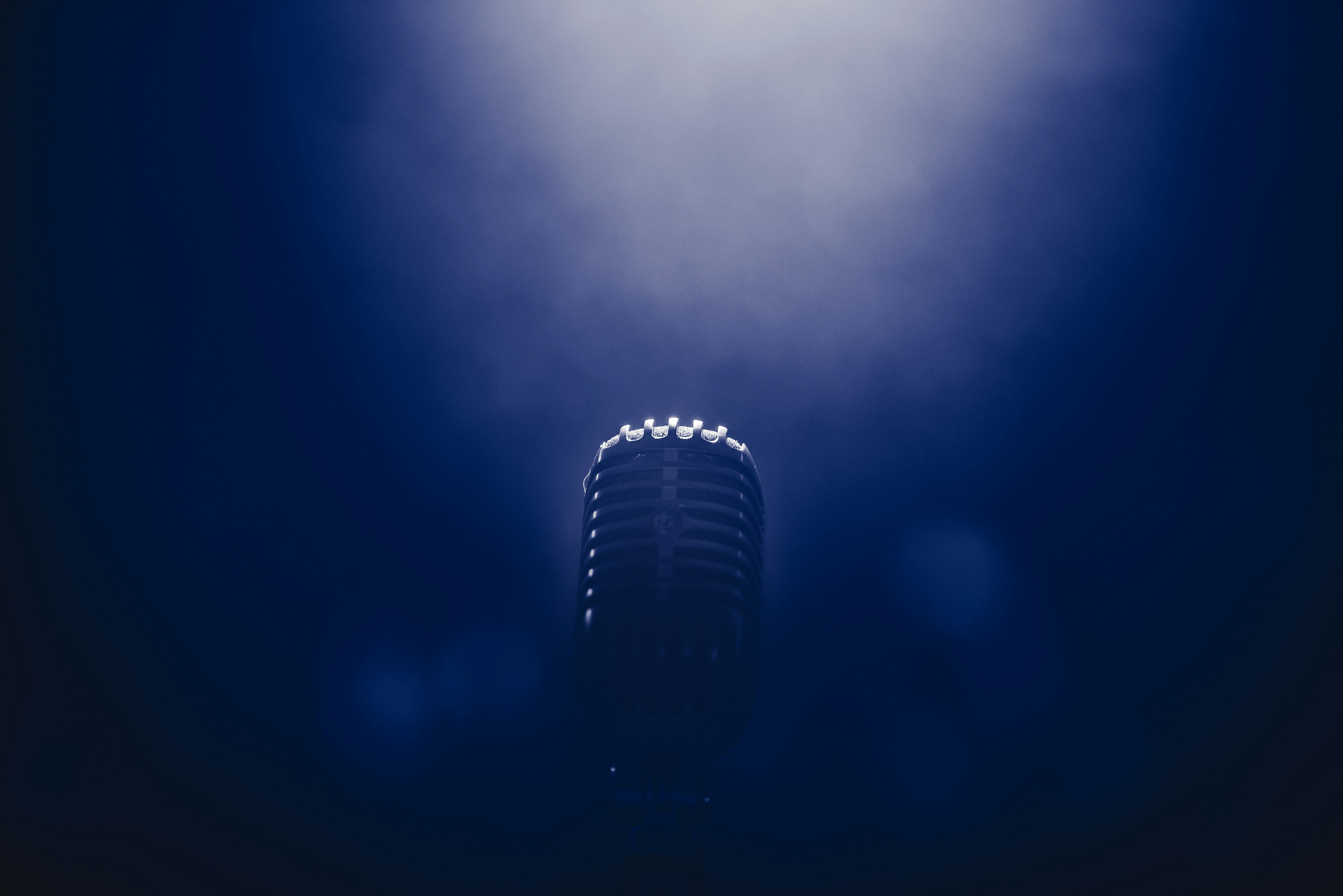 Microphone on a stand under low stage lighting